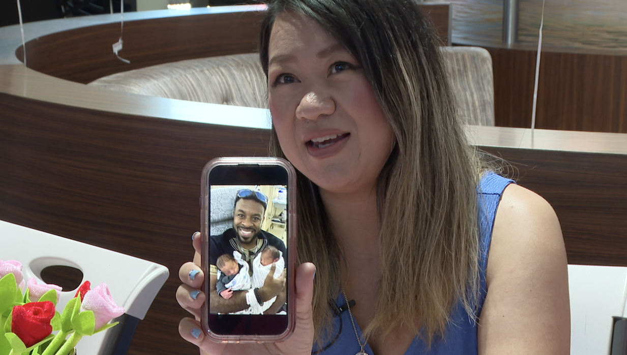 Chaifa Berry holding a picture of her husband and her newly born twin boys. 