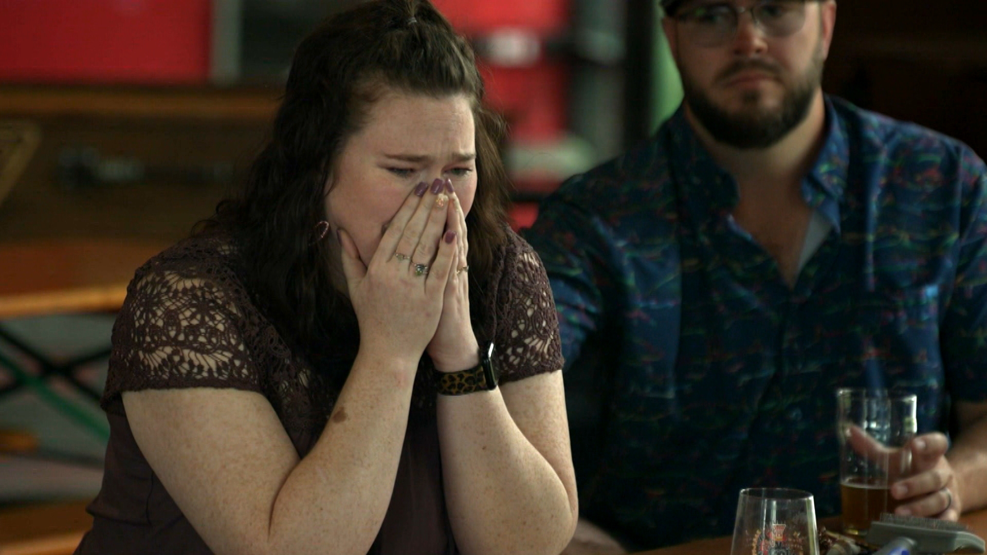 Woman crying at gathering of former patients of the Center for Reproductive Health 