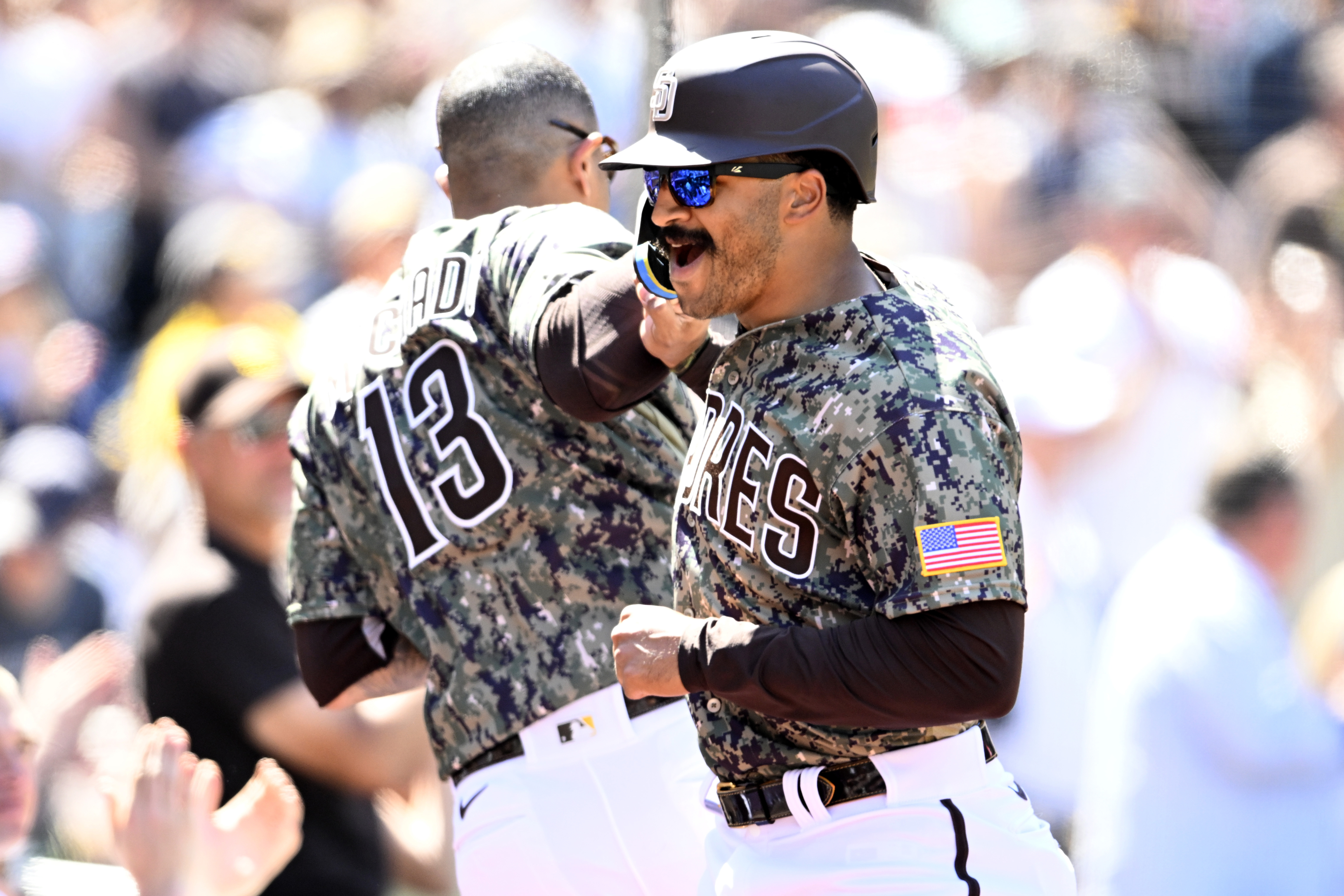 Trent grisham celebrates with machado in camo uni
