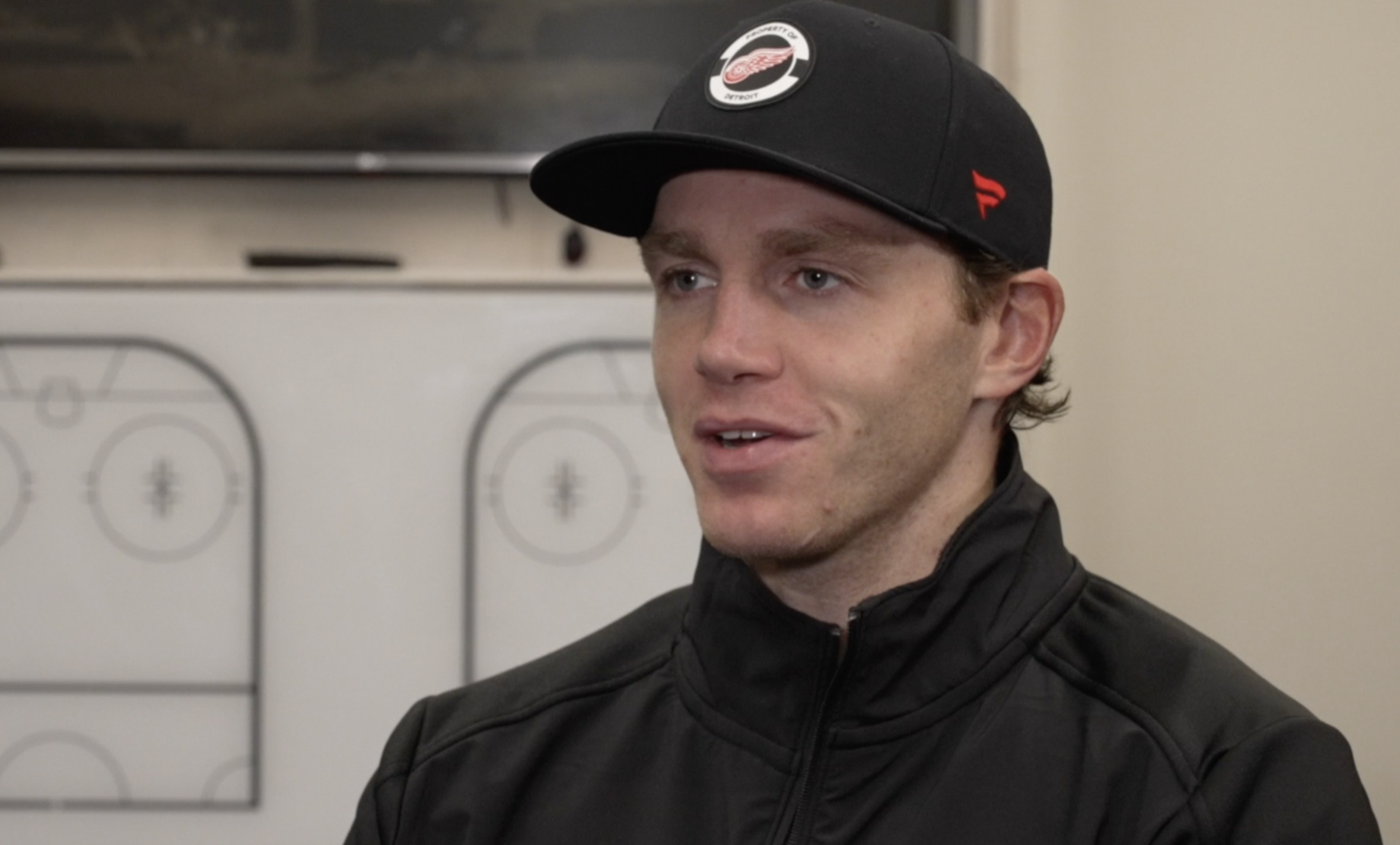 Patrick Kane talks with Brad Galli inside Little Caesars Arena on October 9, 2024