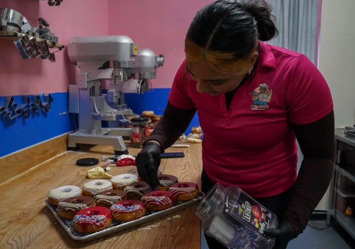 Luz Ramos, owner of Papy Donuts, prepares doughnuts that will be decorated with President Donald Trump's last name in Edinburg on Jan. 24