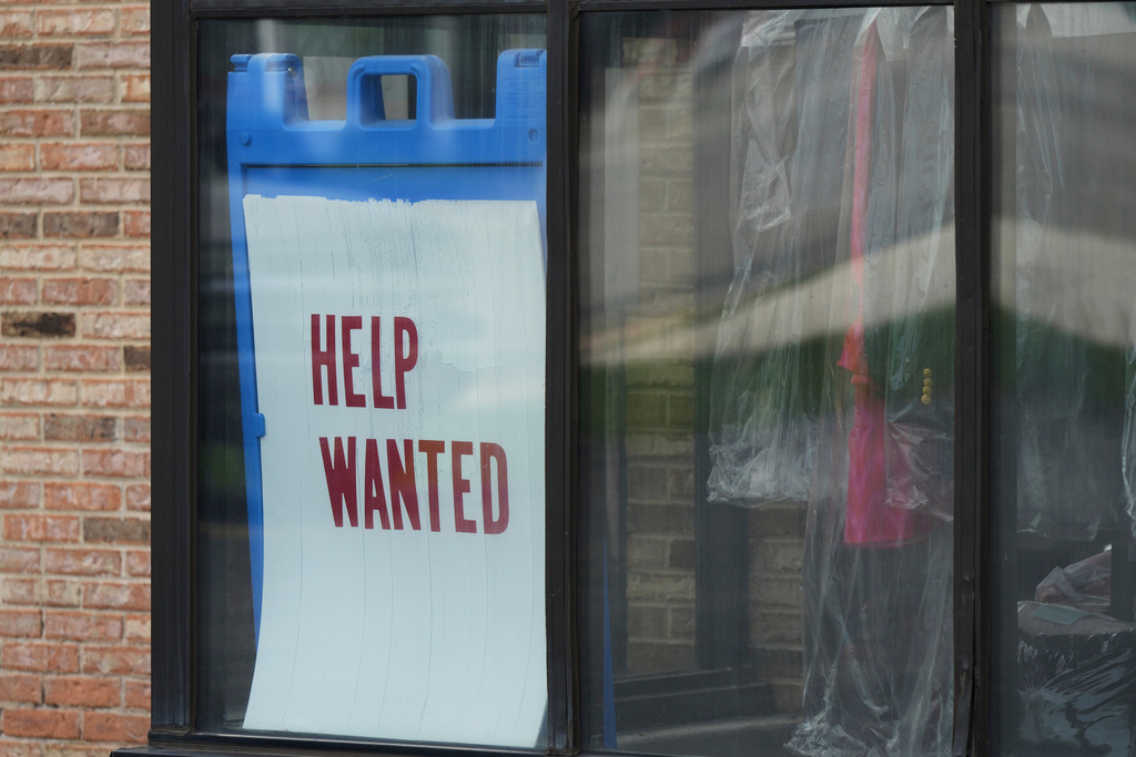 A "Help Wanted" sign is displayed at a business.
