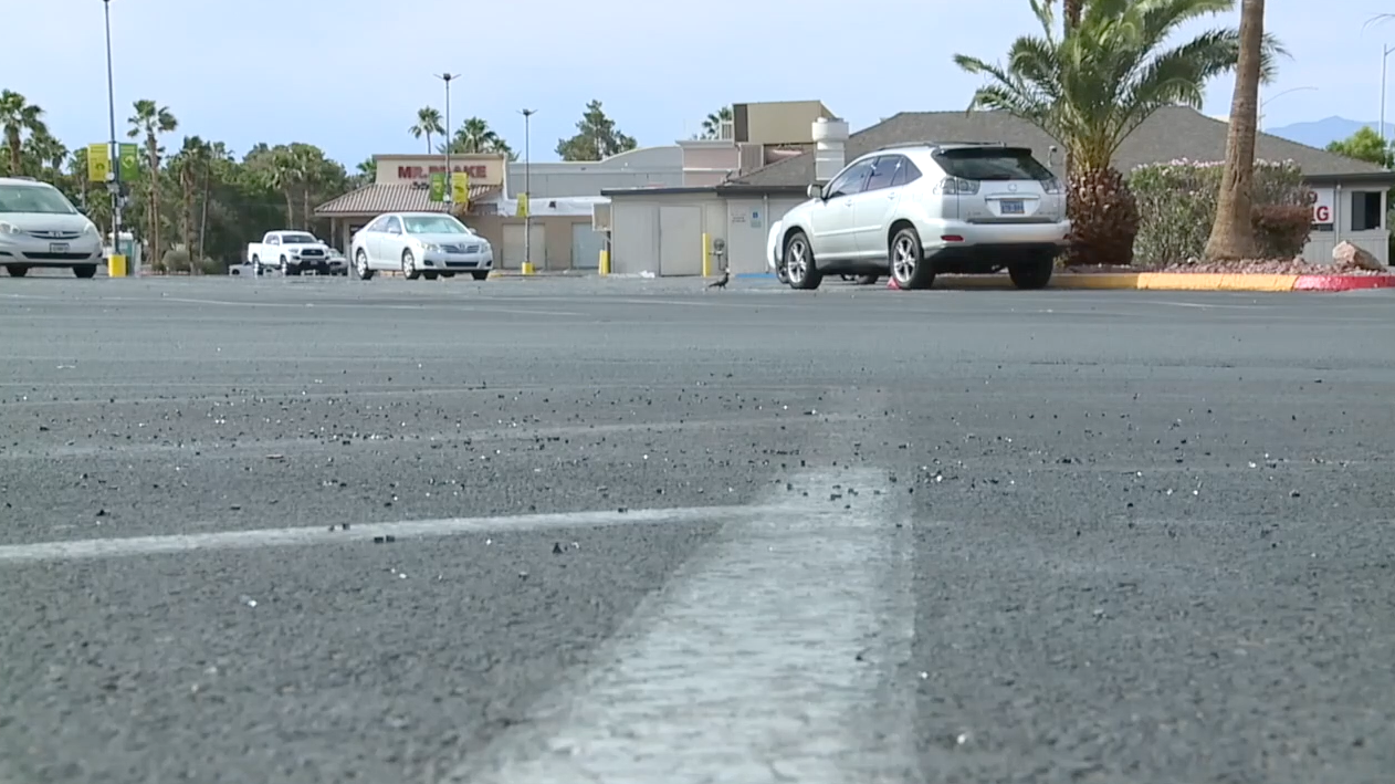 A scene of broken auto glass in a Las Vegas parking lot amid rise in car thefts in the valley.