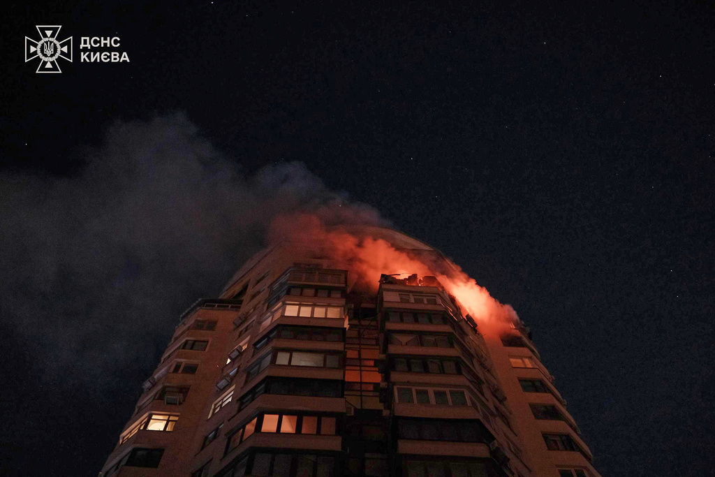 In this photo provided by the Ukrainian Emergency Service, emergency services personnel work to extinguish a fire at a multi-storey apartment building following a Russian attack in Kyiv, Ukraine, Tuesday, Feb. 3, 2026.