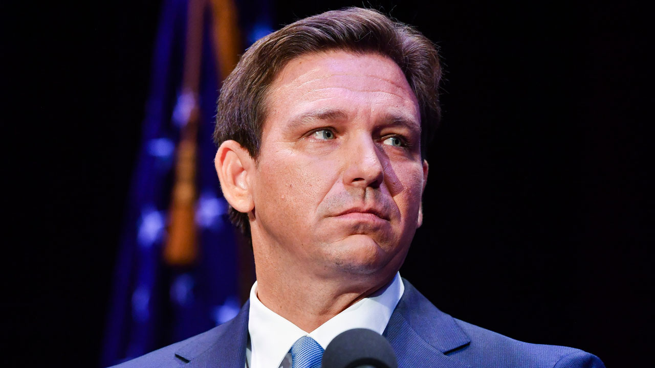 Florida's Republican Gov. Ron DeSantis takes to the stage to debate his Democratic opponent Charlie Crist in Fort Pierce, Fla., on Oct. 24, 2022. 