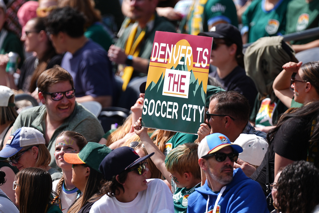 A fan of Denver Summit FC holds up placard in the first half of an NWSL soccer match against the Washington Spirit, Saturday, March 28, 2026, in Denver.