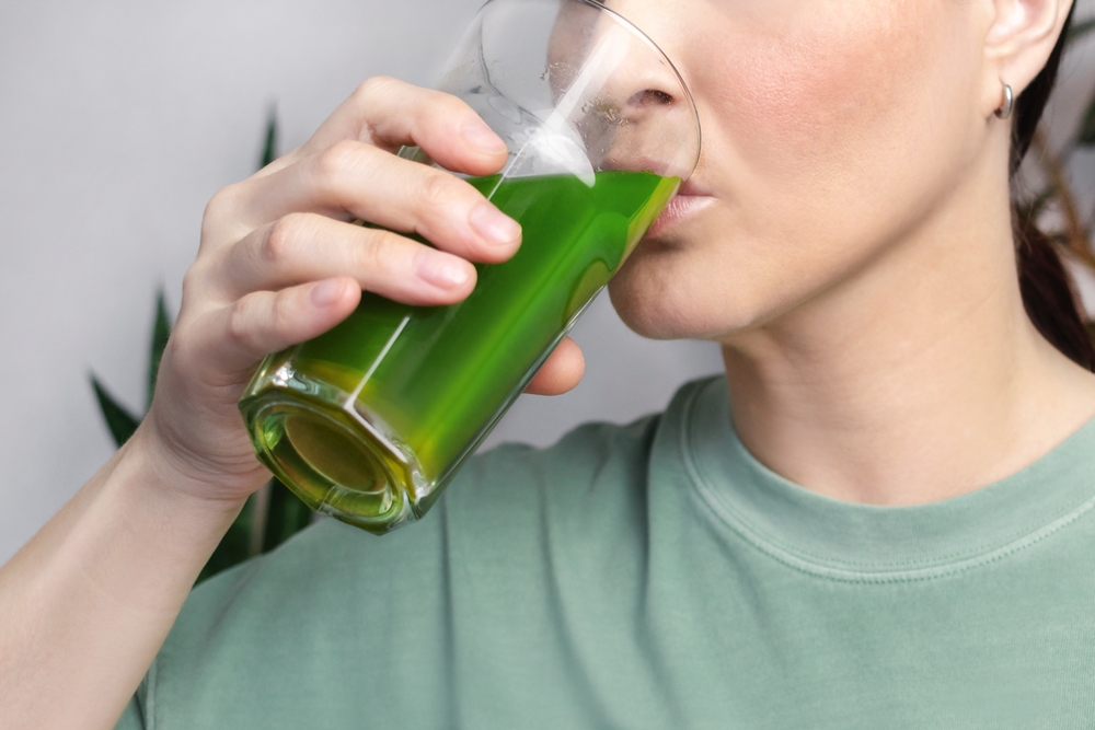 Woman,Drinks,Green,Wheatgrass,Energy,Shake.,Close,Up,Photo