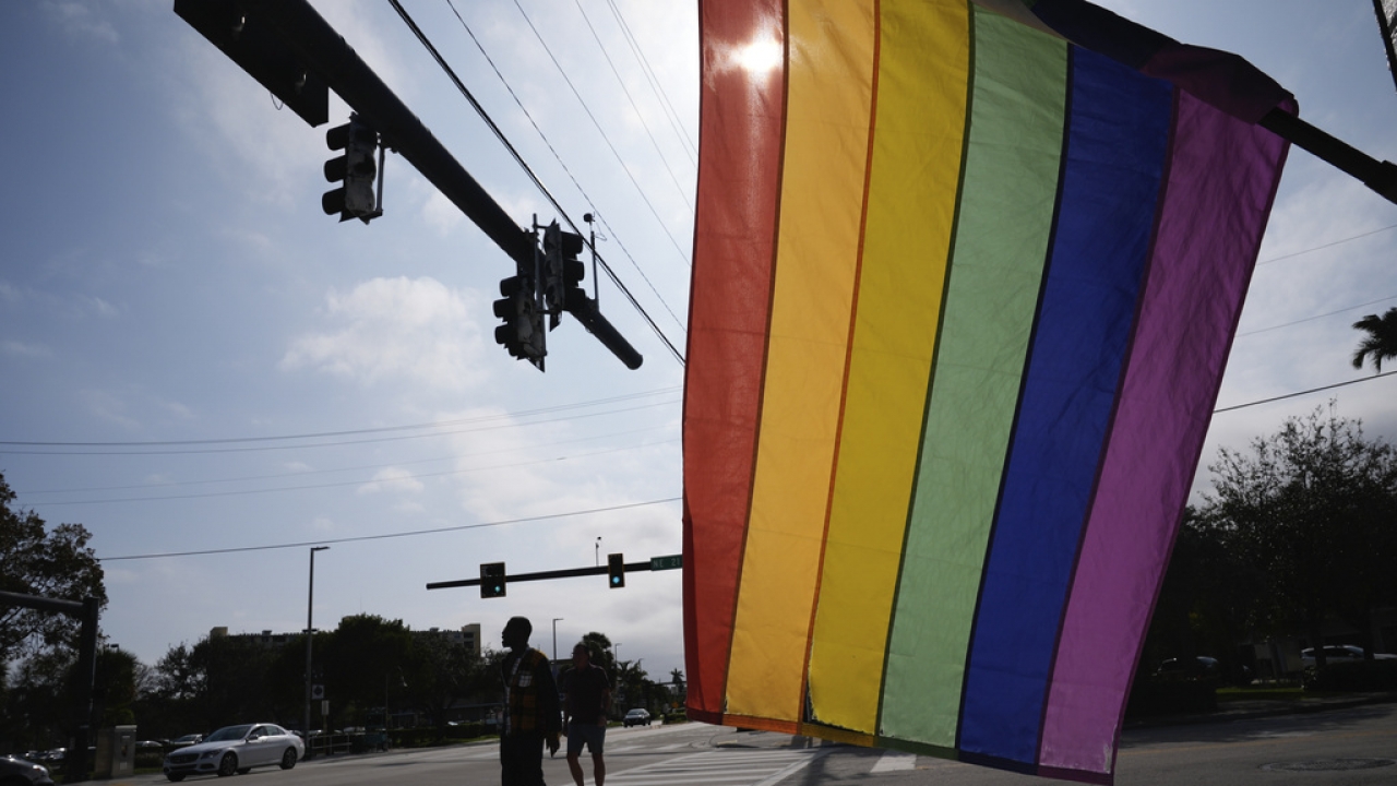 A rainbow LGBTQ+ pride flag hangs outside in Florida.