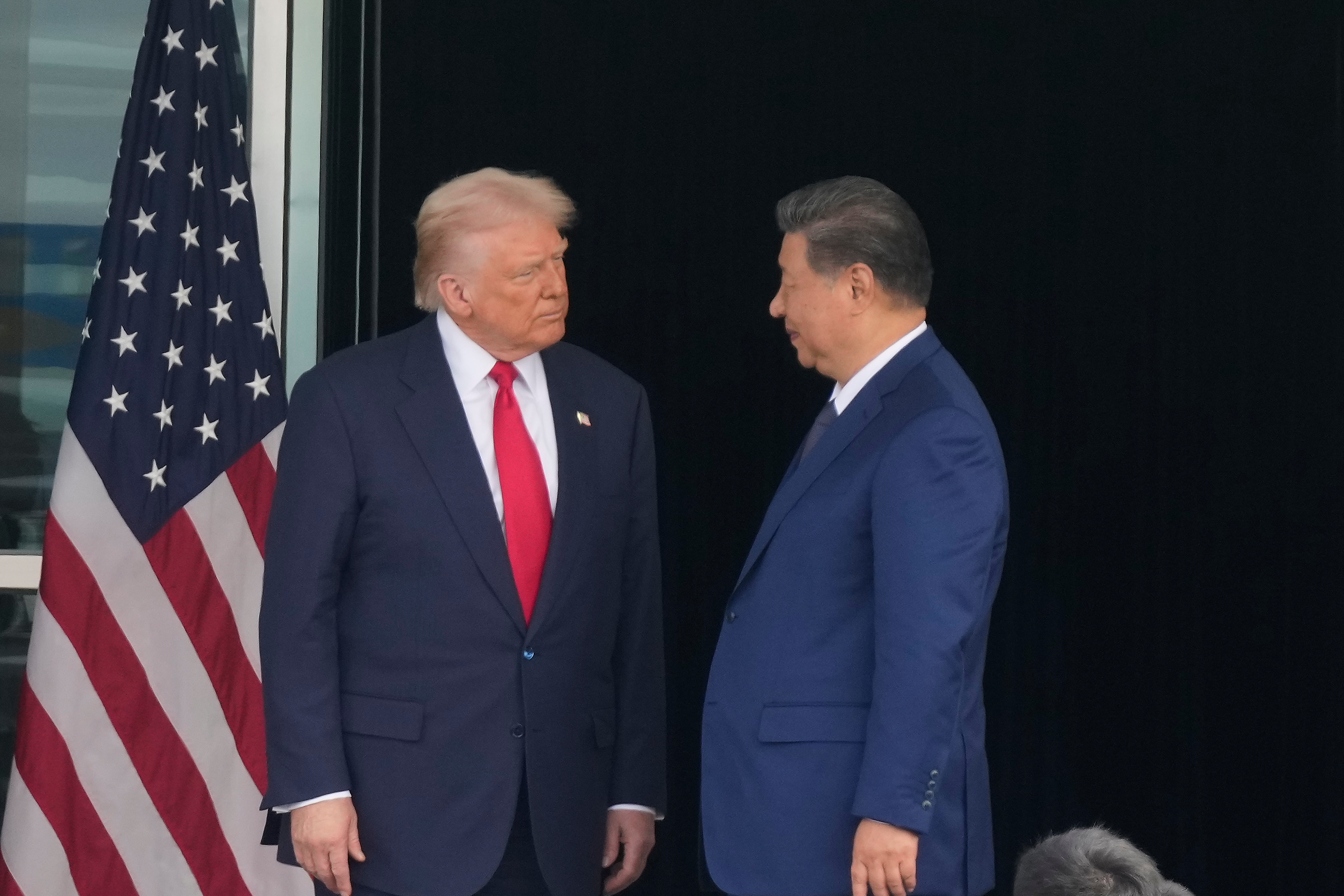 President Donald Trump, left, and Chinese President Xi Jinping, look at each other after their summit meeting at Gimhae International Airport Jinping in Busan, South Korea, Thursday, Oct. 30, 2025. 