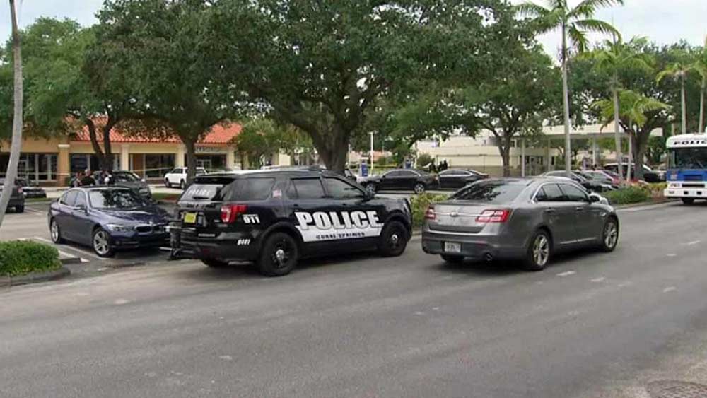 A detective was hospitalized after being struck by a suspect's car in Coral Springs, police said.