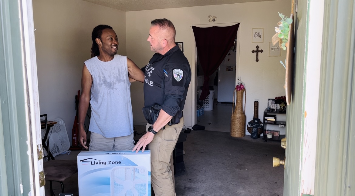Constable Guy Beveridge delivers fan to Sedrick Hopkins