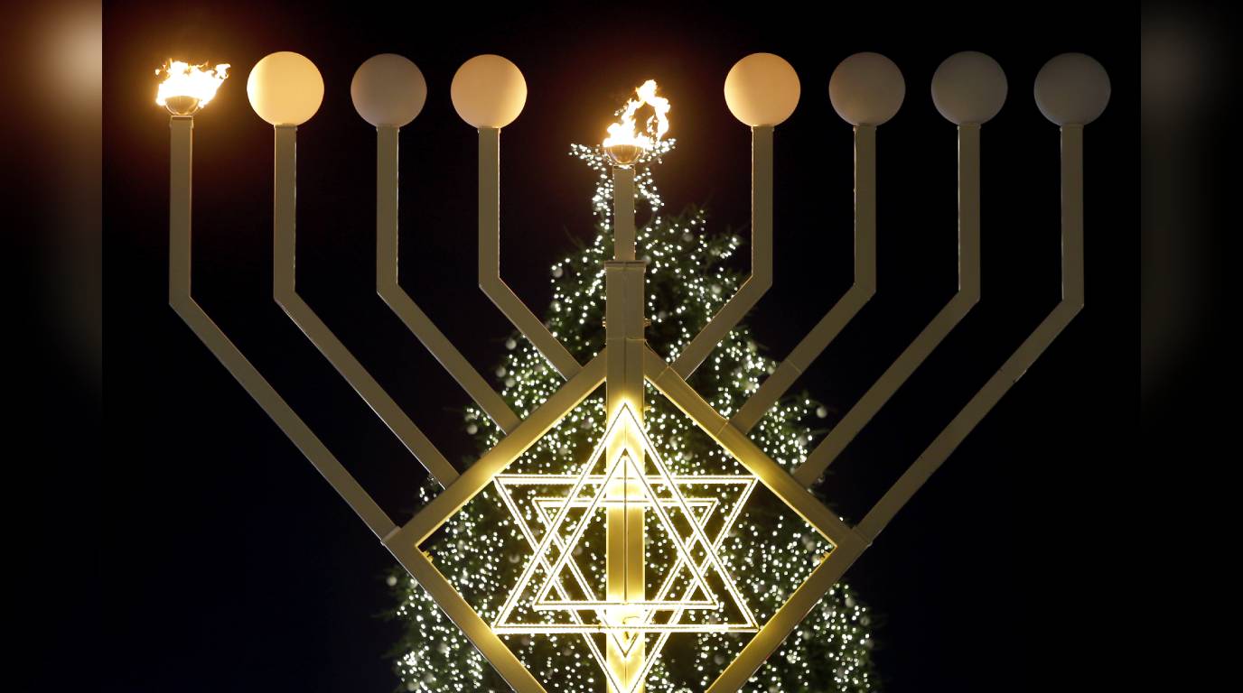 FILE IMAGE: A giant Hanukkah Menorah in front of a Christmas tree.  