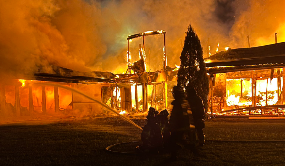 A home on LeLac Road in west Delray Beach is engulfed in flames on Nov. 28, 2023.PNG