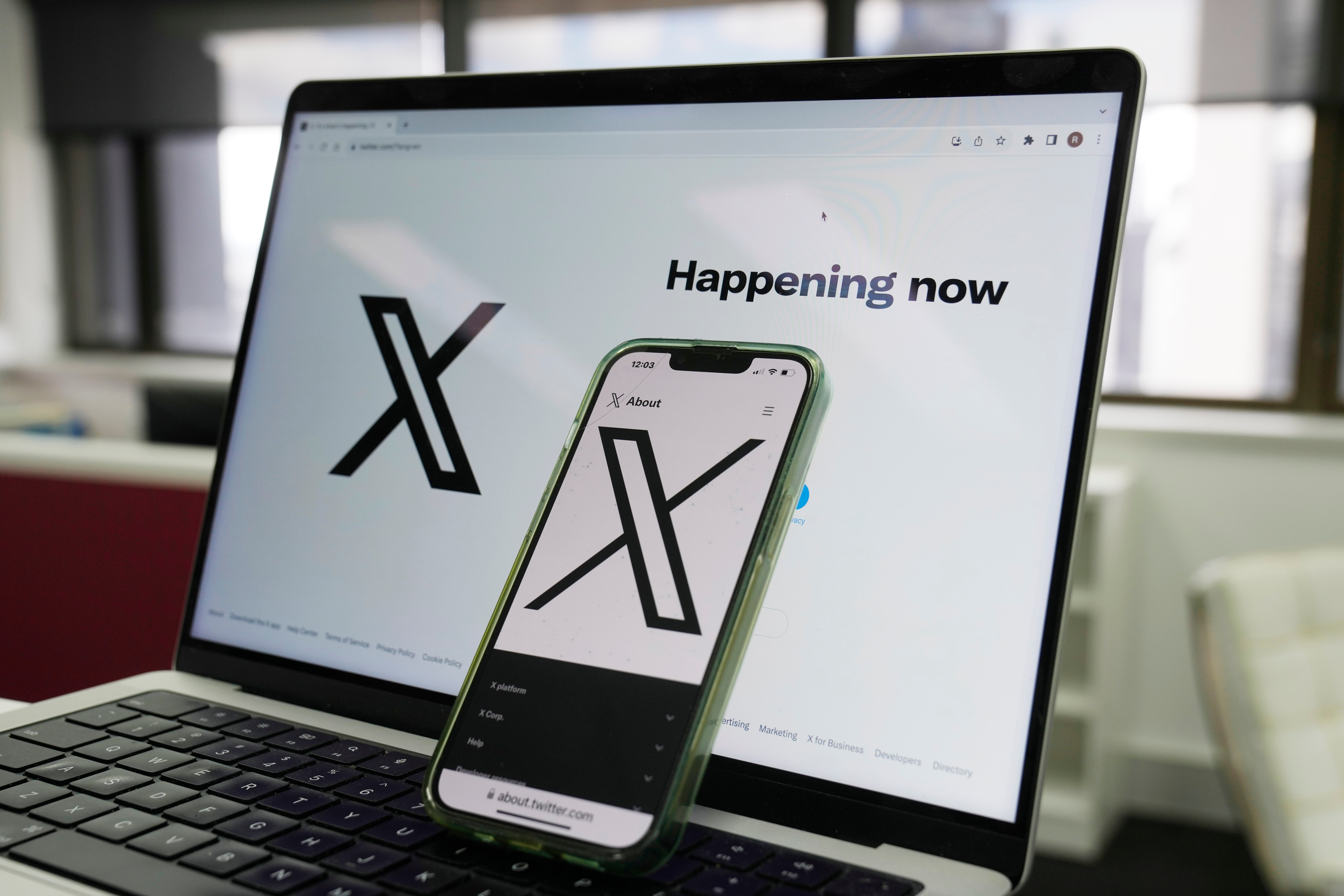 he opening page of X is displayed on a computer and phone, Oct. 16, 2023, in Sydney. (AP Photo/Rick Rycroft, File)