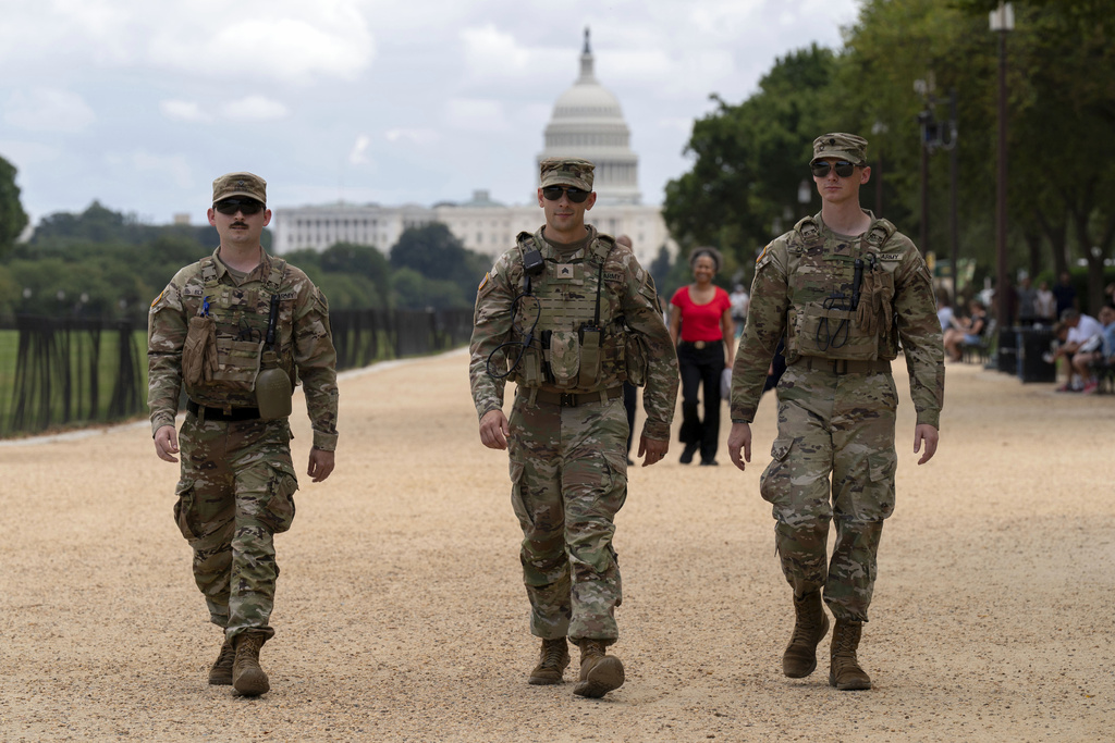 Members of the Louisiana National Guard patrol the National Mall, Sunday, Aug. 24, 2025, in Washington.