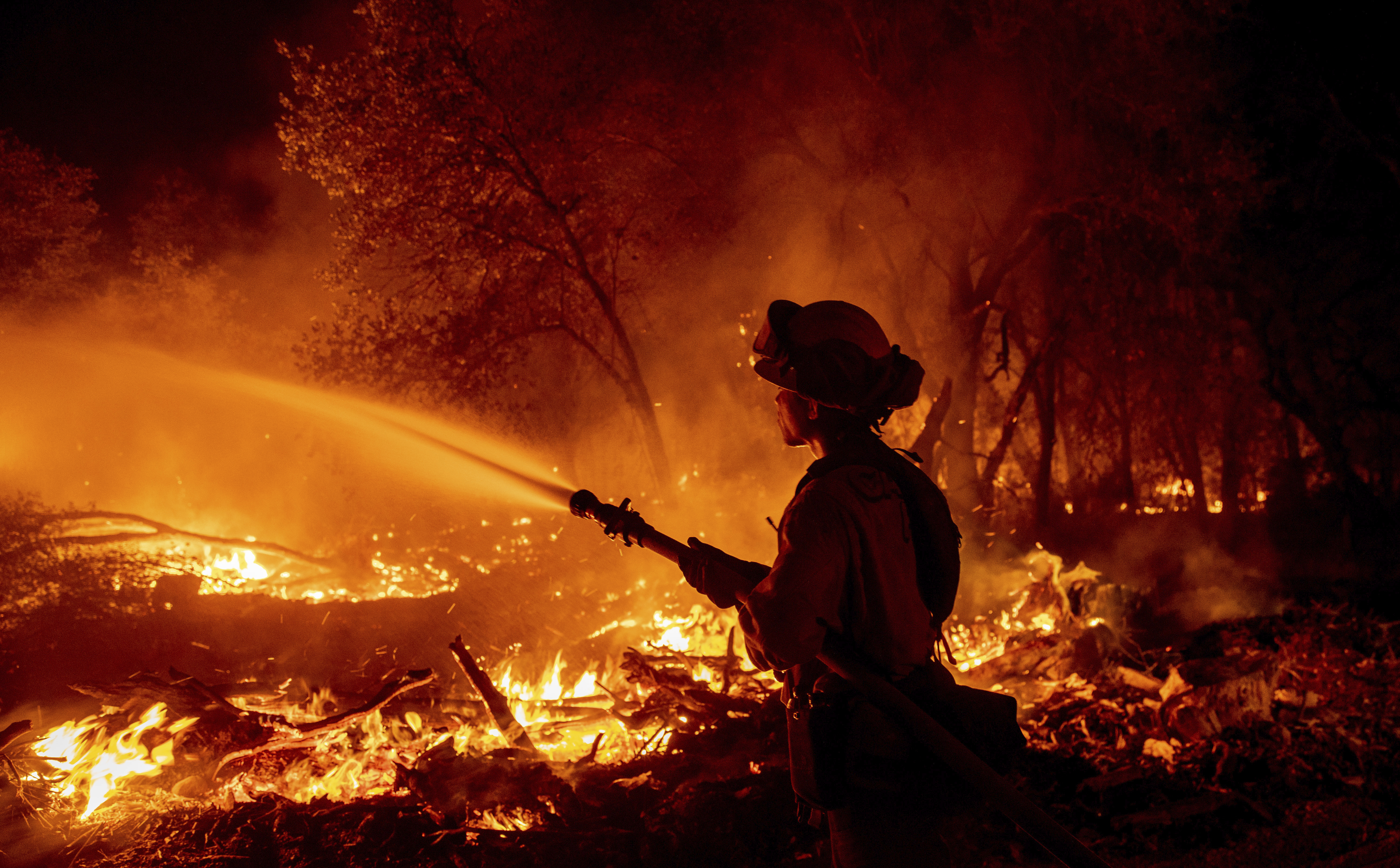 Firefighter Ron Burias battles the Fawn Fire as it spreads