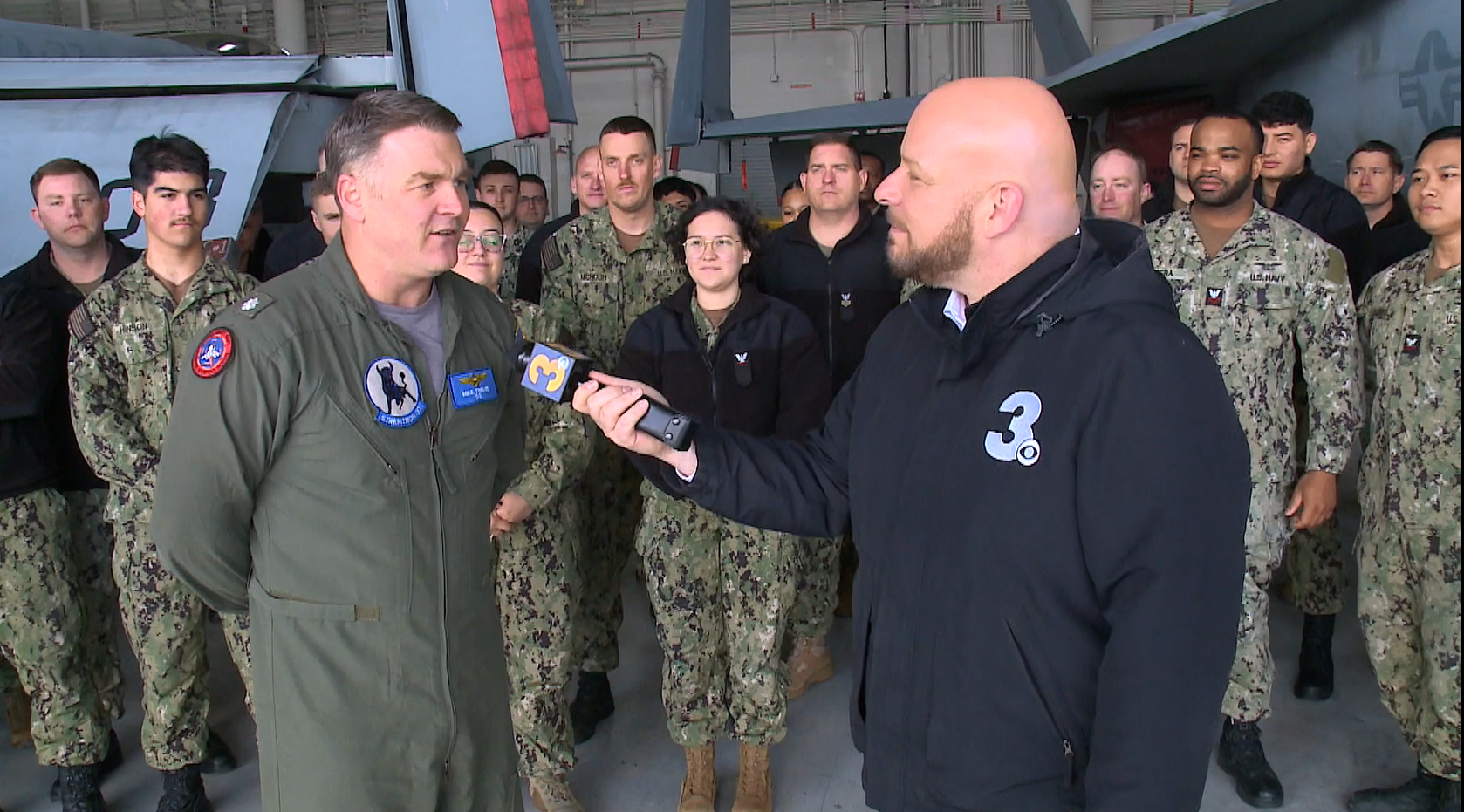 News 3 anchor Blaine Stewart interviews VFA-37's commanding officer