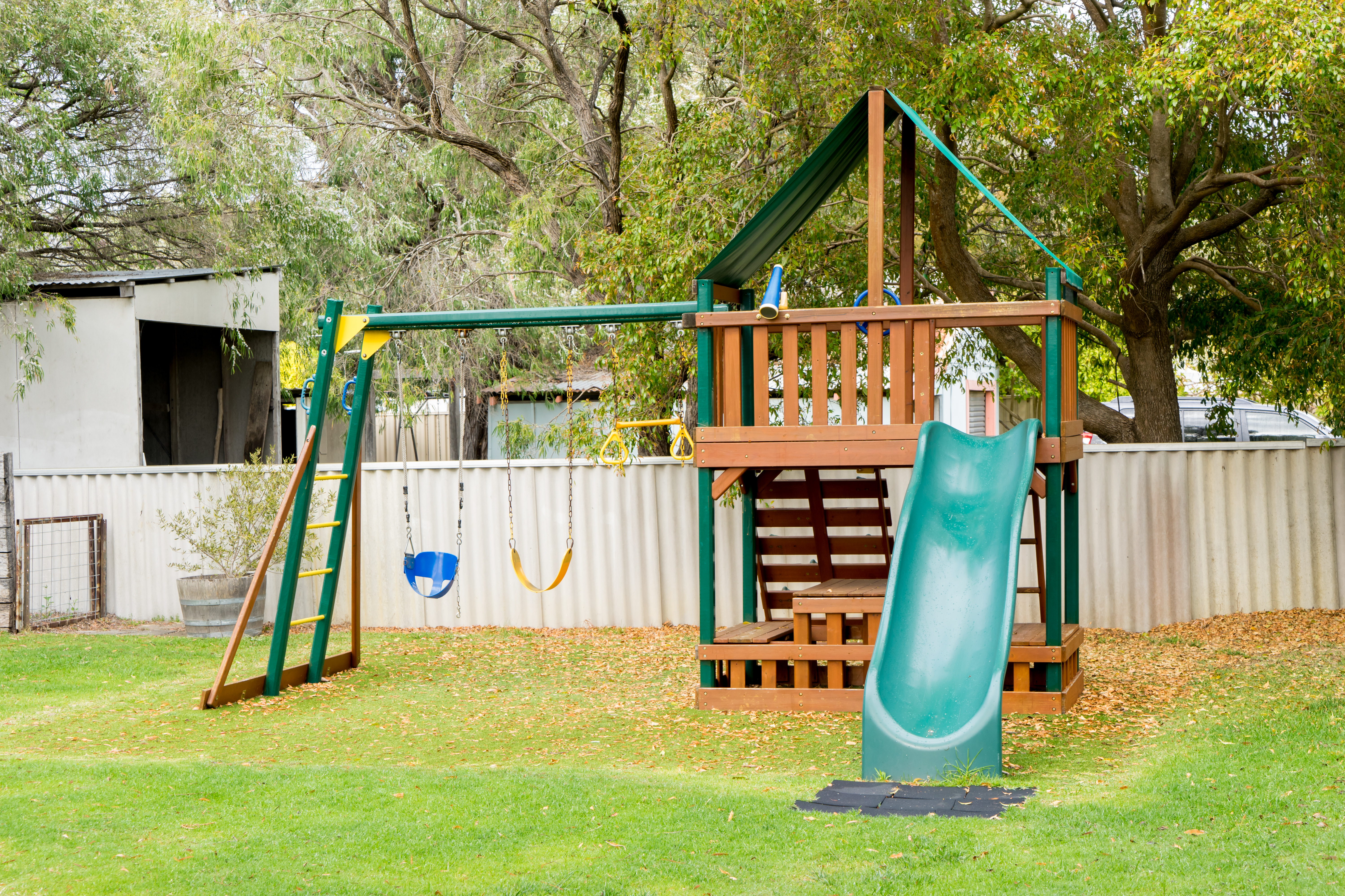 view-of-kids-playground-in-green-backyard-garden-SBI-301985440.jpg