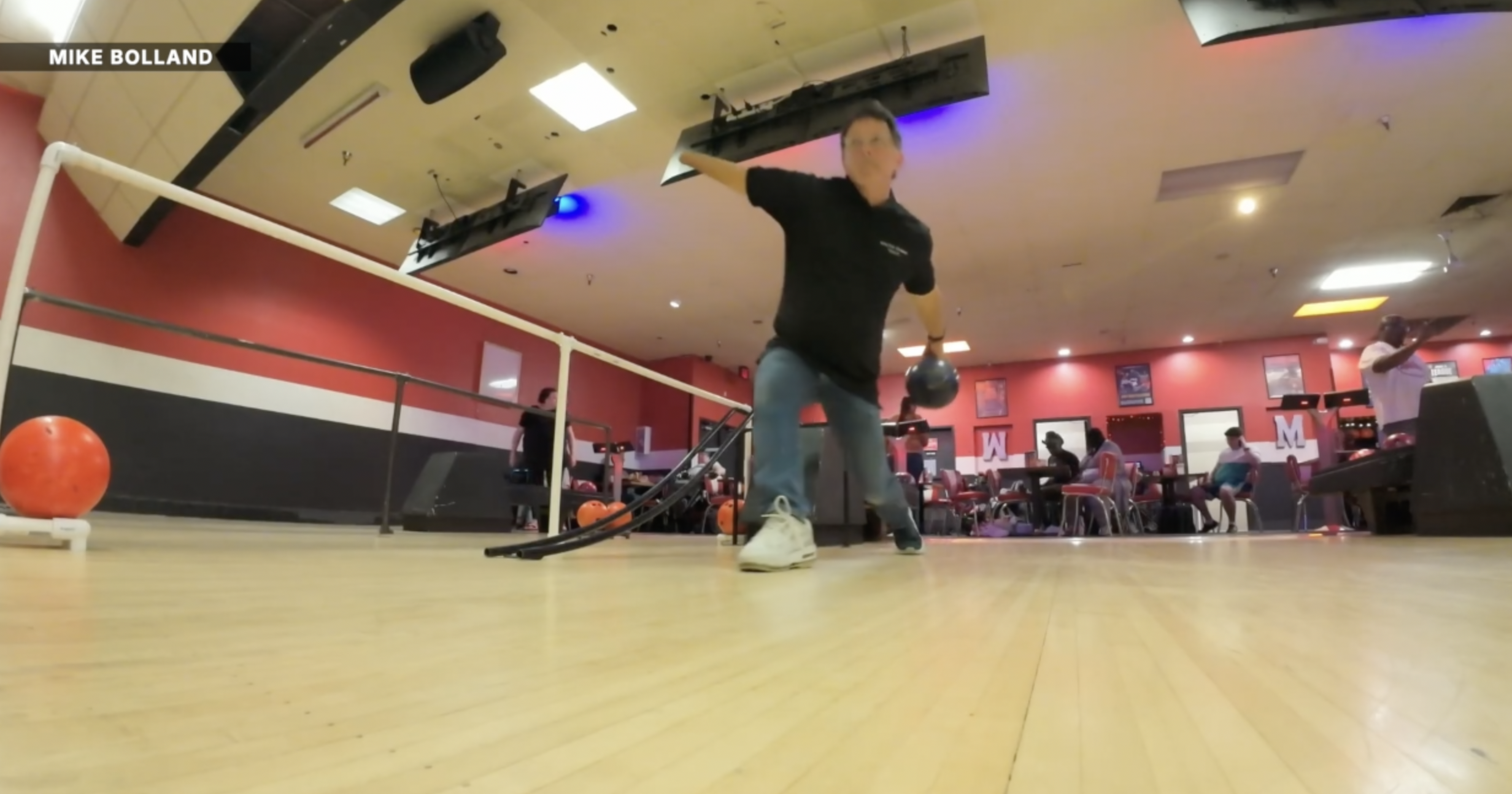 A photo of Mike Bolland bowling.