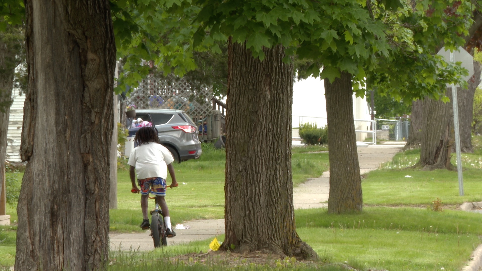 Kid on his bike on Biddle Street in Jackson days after a mass shooting there