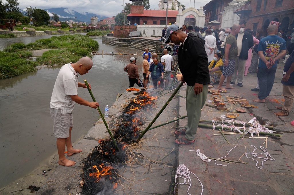 Men perform rituals during symbolic last rites for their relatives who remain missing and are presumed dead following flash floods in Kathmandu, Nepal, Wednesday, Sept. 2, 2026.