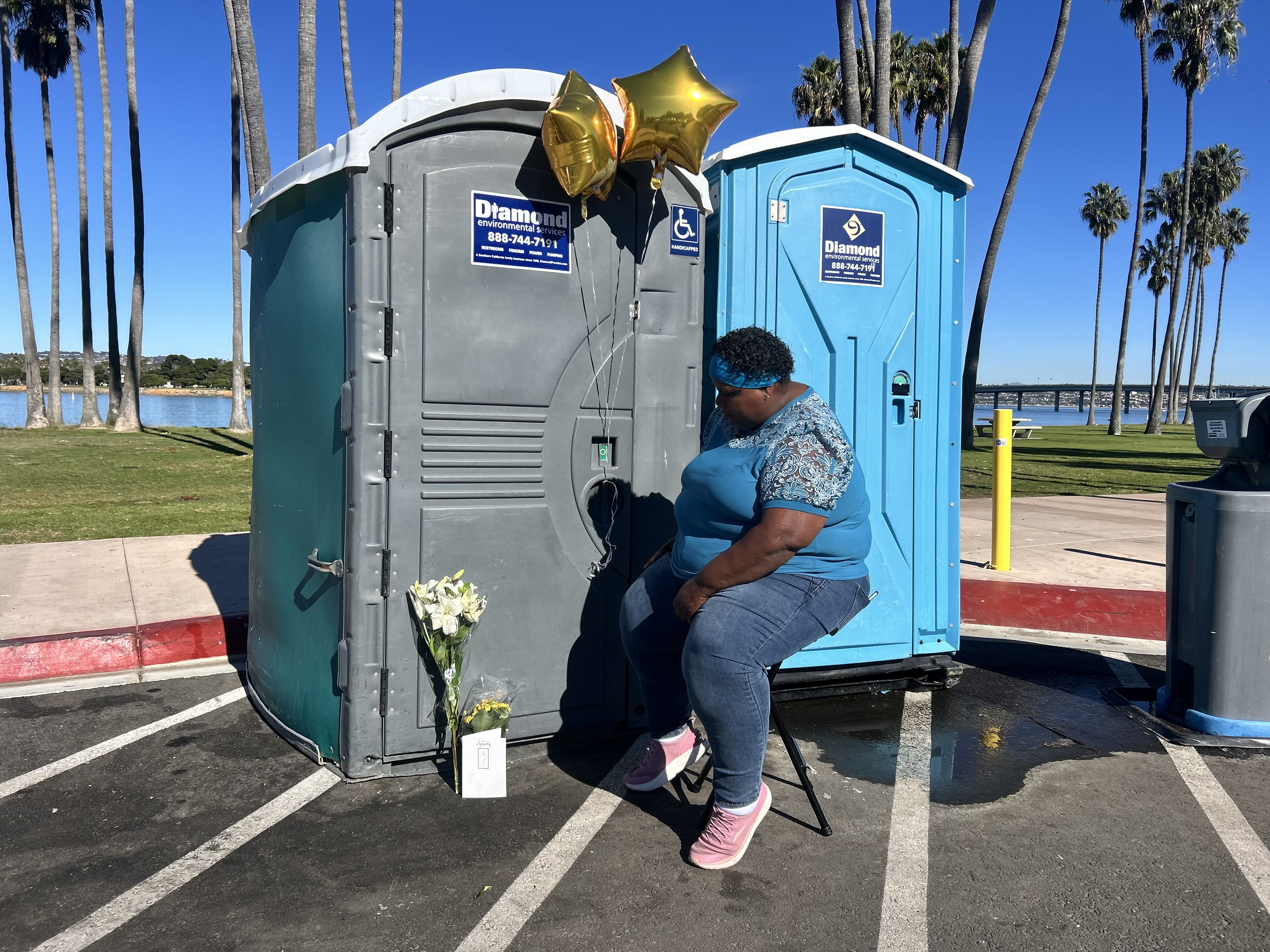 woman in front of portable restroom where infant was found dead