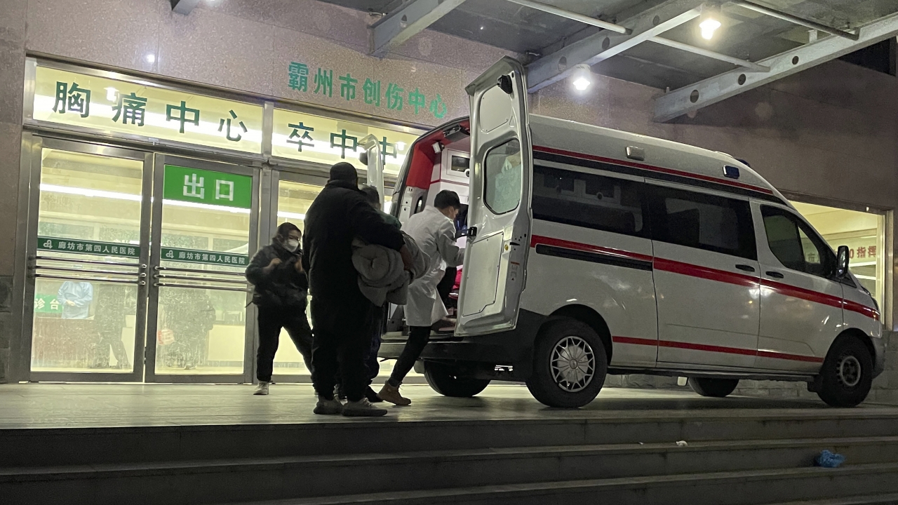 An ambulance prepares to transfer a patient in critical care to other hospitals due to overcapacity.