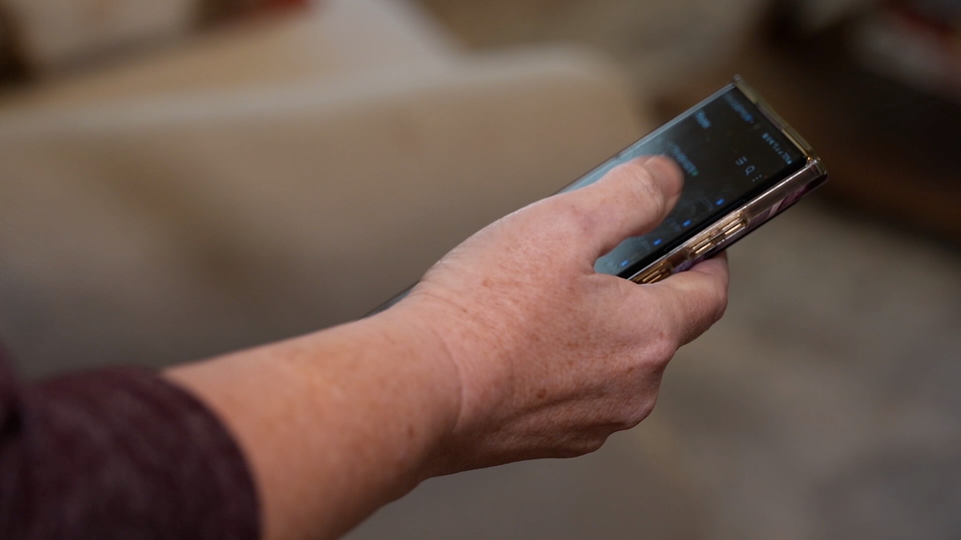 Woman holds phone after imposter calls her 