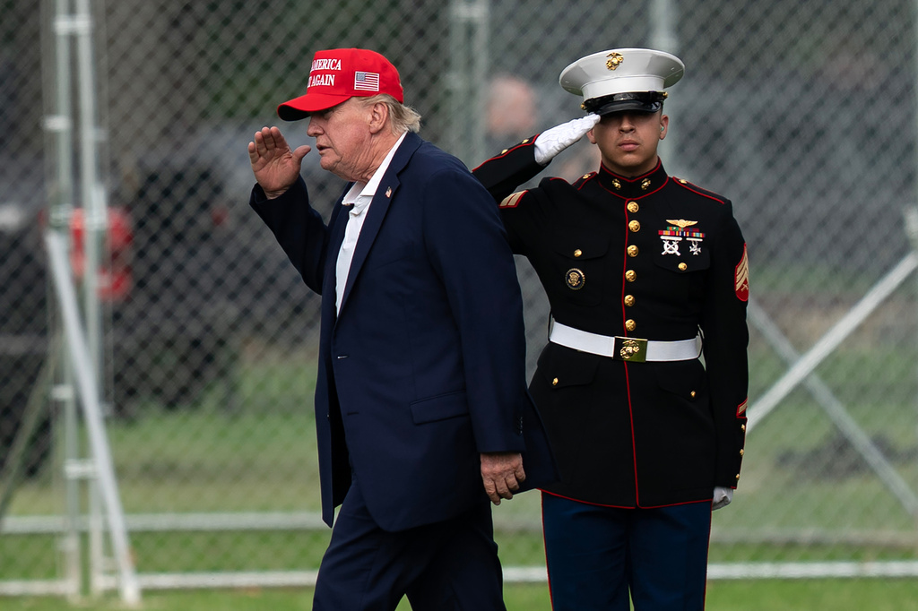 President Donald Trump returns a salute as he walks from Marine One to his limousine upon his arrival at the Ellipse just outside of the White House, Sunday, Aug. 16, 2026, in Washington.