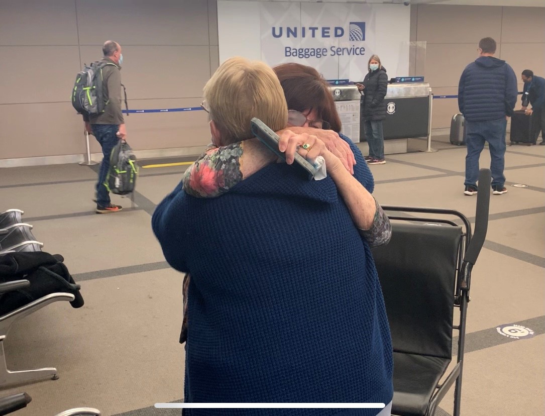 sisters embrace at DIA.jpg