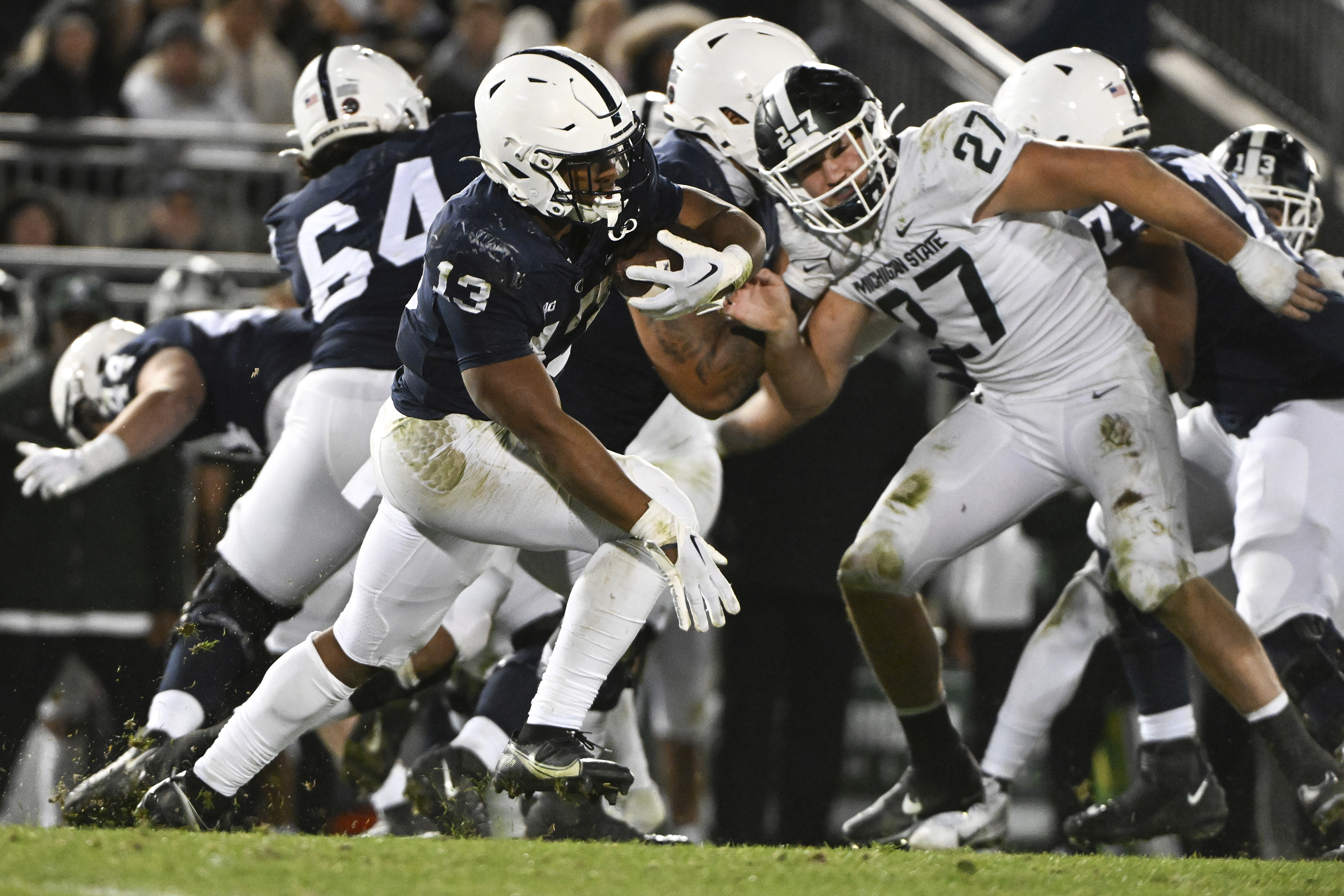 Penn State Nittany Lions running back Kaytron Allen runs past Michigan State Spartans linebacker Cal Haladay, Nov. 26, 2022