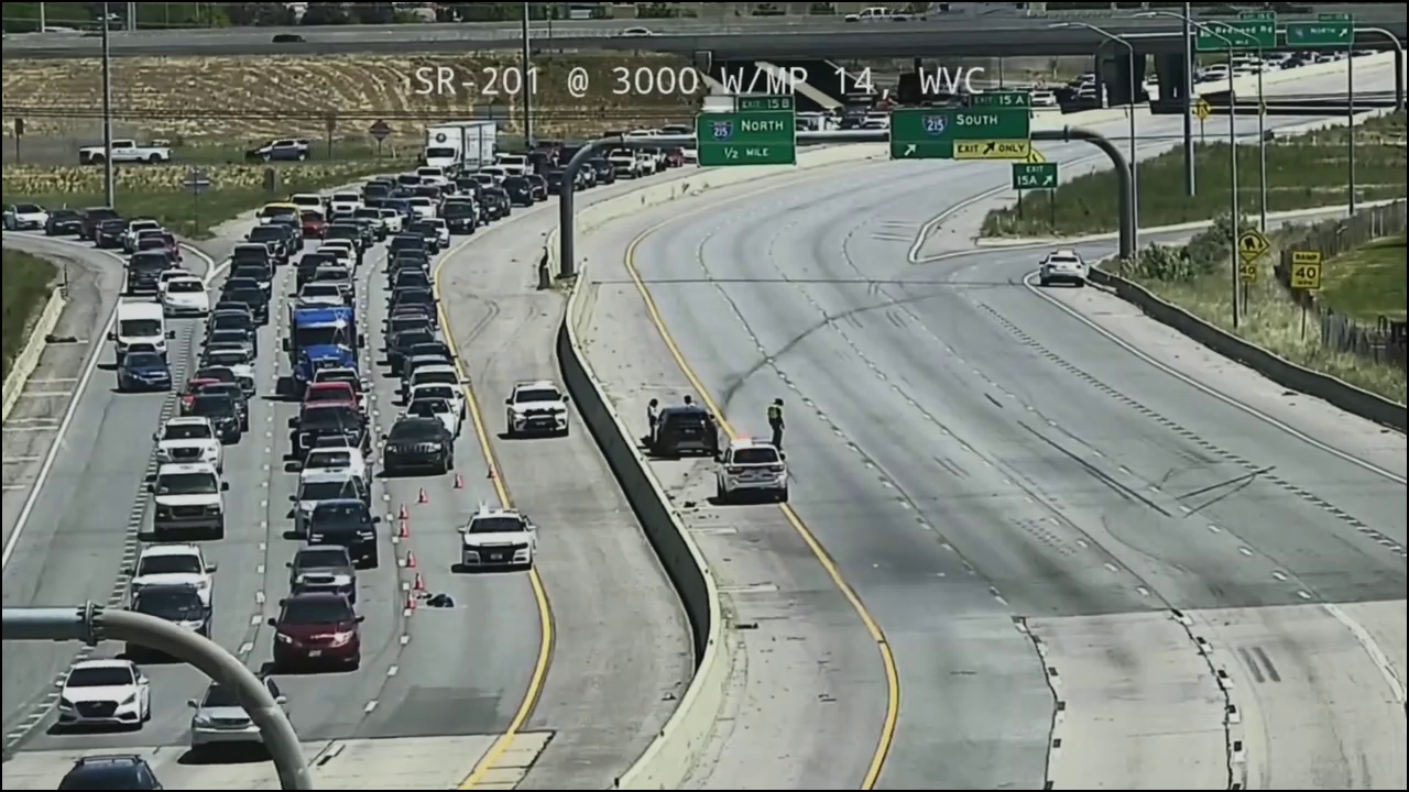 A still from a UDOT traffic camera looking over the scene. It's daytime, and the eastbound lanes are completely empty, while westbound traffic is bumper-to-bumper.
