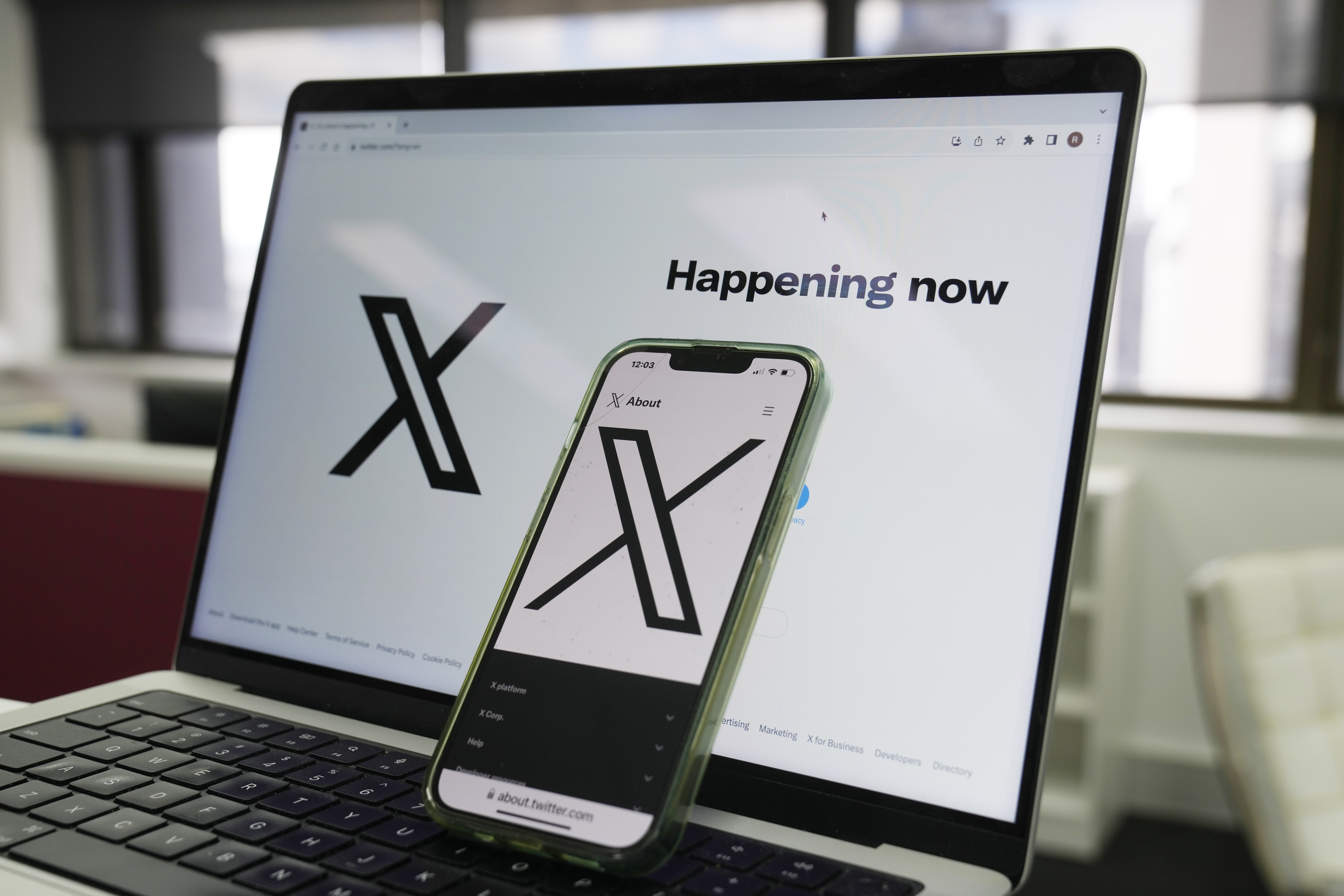 FILE - The opening page of X is displayed on a computer and phone in Sydney on Oct. 16, 2023. 