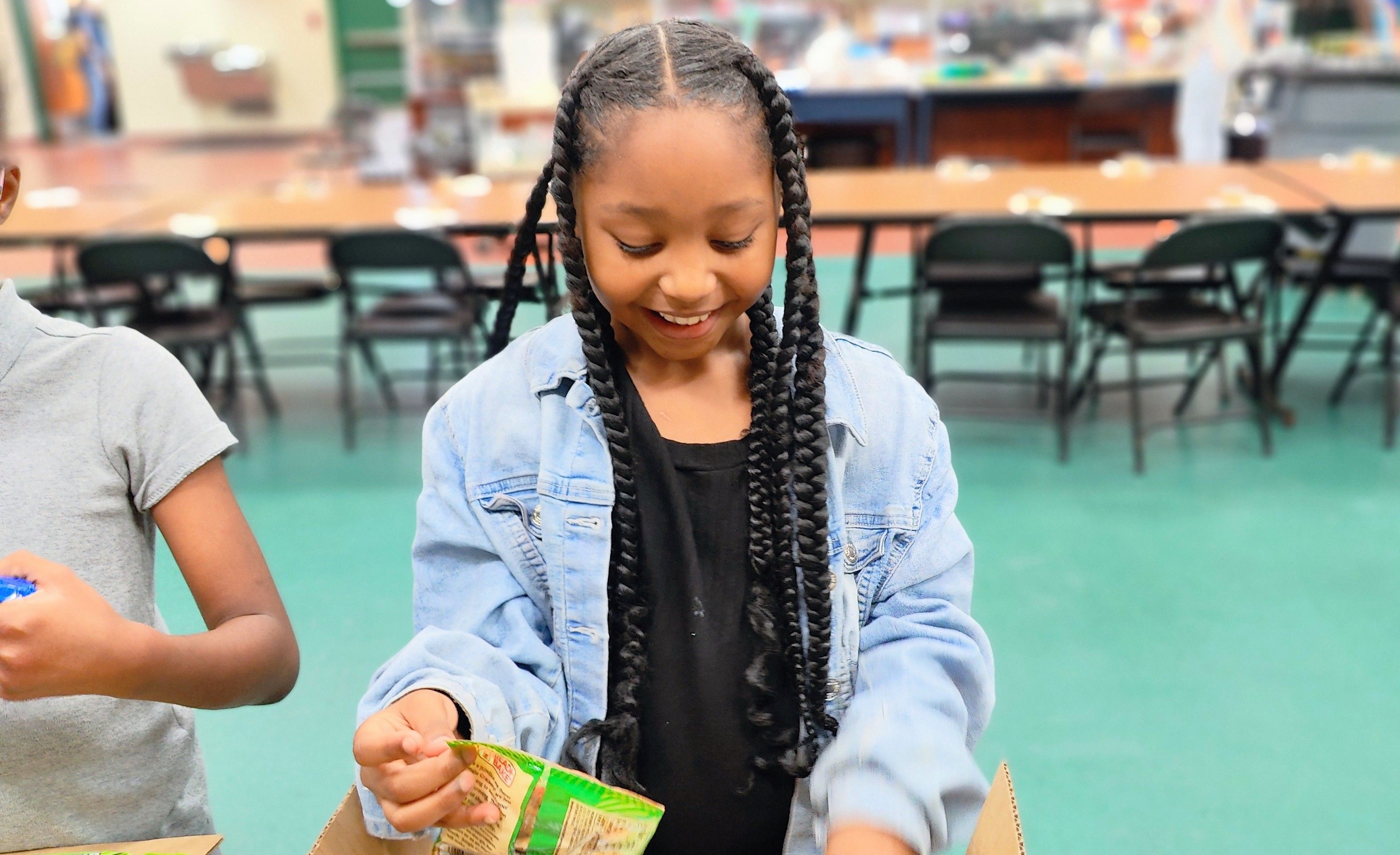 Child Receiving a KidsPack Boca Helping Hands.jpeg