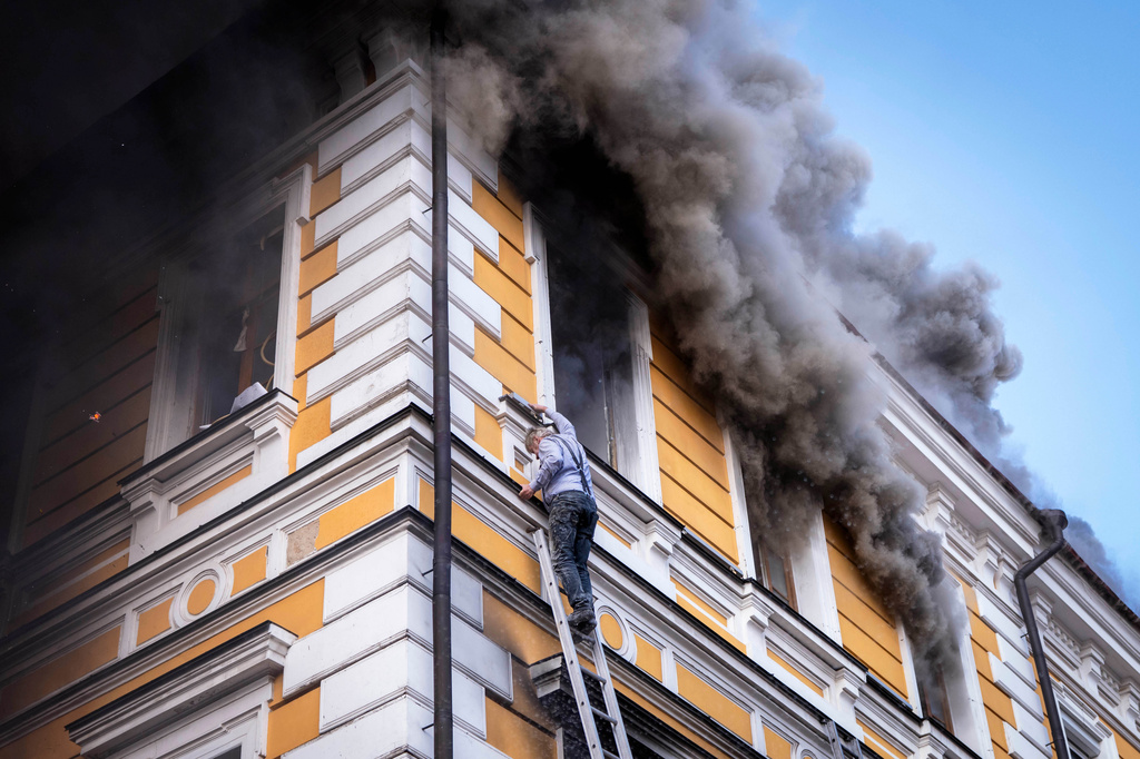 A man evacuates a burning building using a rescue ladder from the National Academy of Sciences building damaged after a Russian drone strike in the center of Kyiv, Ukraine, Monday, Sept. 28, 2026. 
