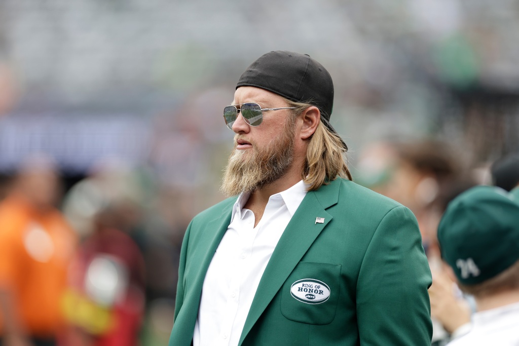 Former New York Jets player Nick Mangold walks the field before an NFL football game against the Cincinnati Bengals, Sept. 25, 2022, in East Rutherford, N.J.