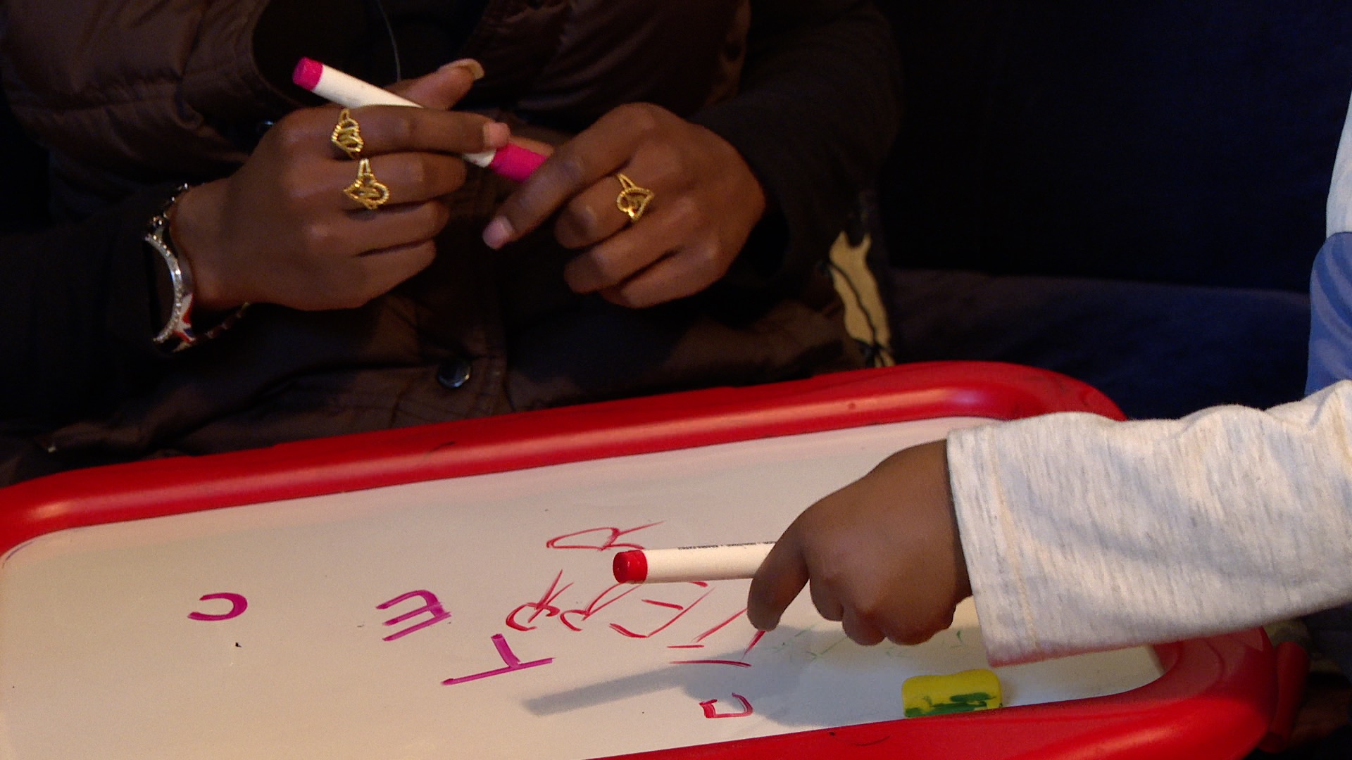 Victoria and TJ Arnold practicing writing letters