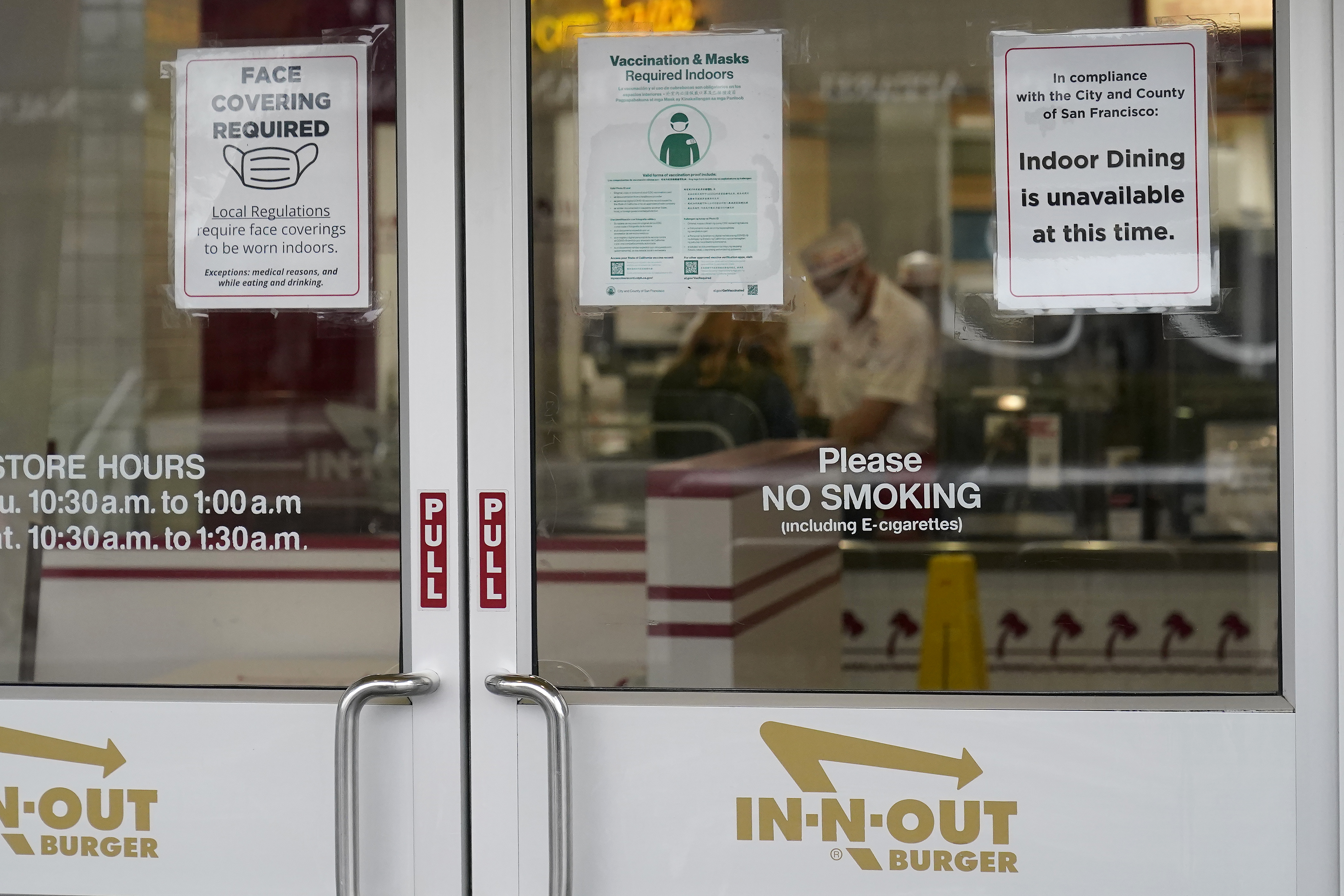 In-N-Out Burger signs requiring face masks and vaccinations