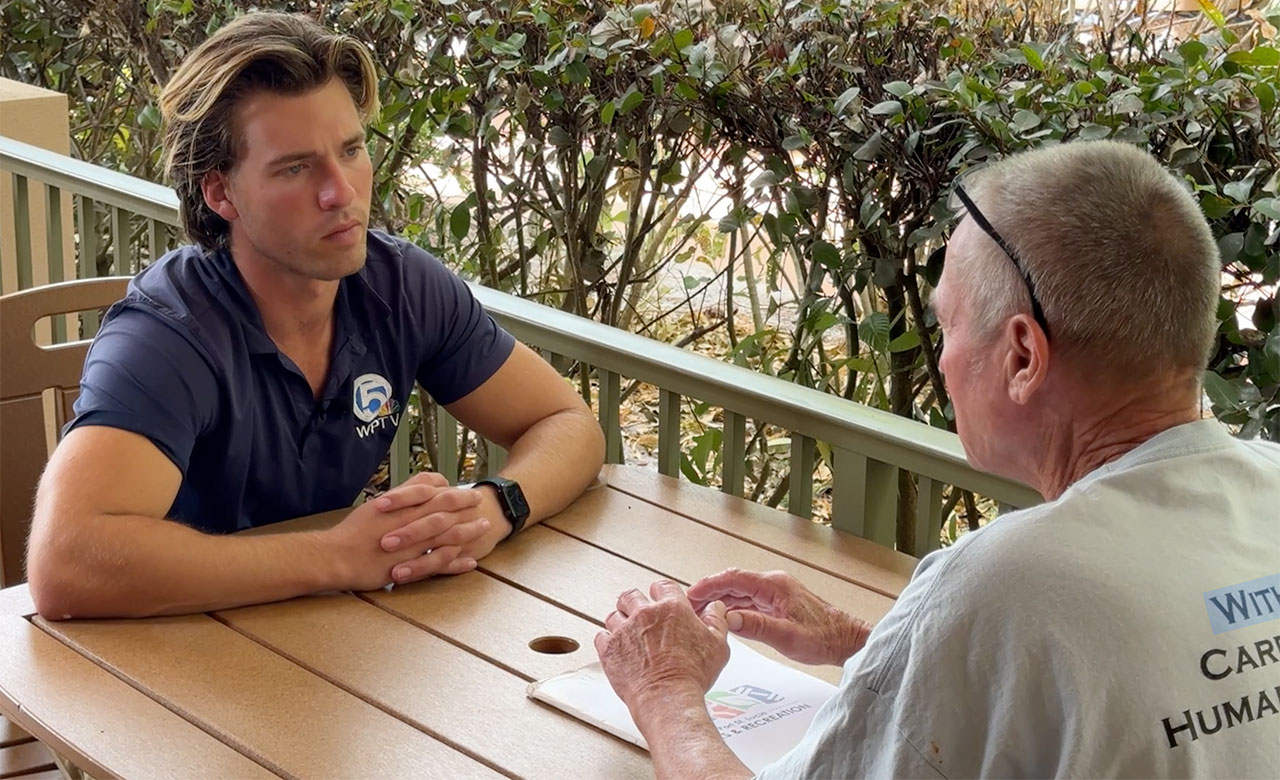 WPTV reporter Tyler Hatfield speaks to a member of the community at a Let's Hear It event in Port St. Lucie on Feb. 18, 2026.