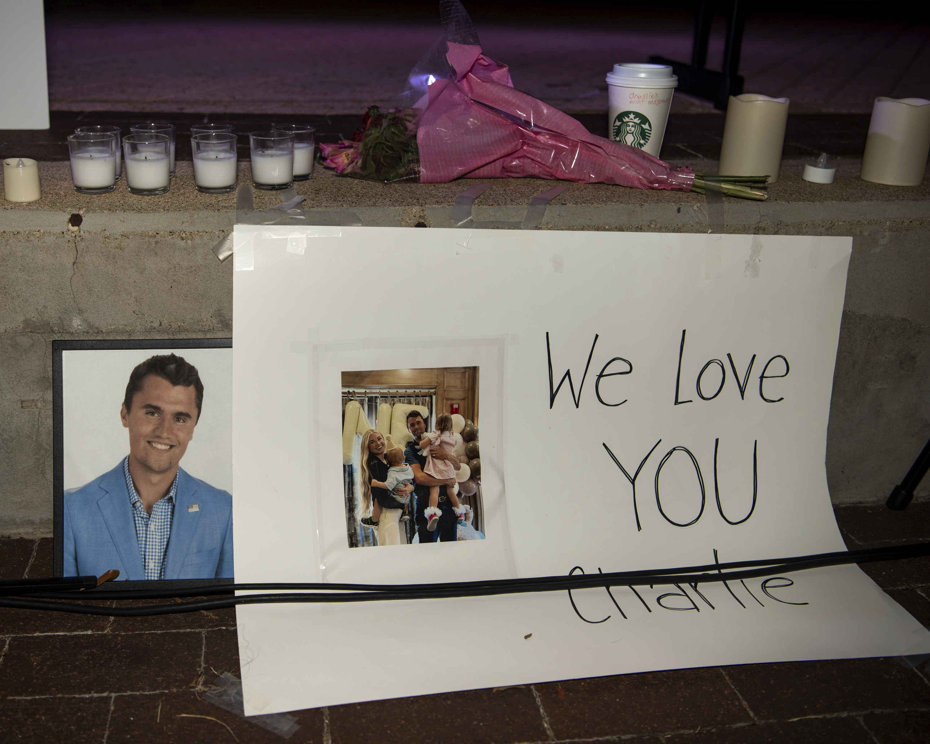Flowers and images are left as a makeshift memorial for Charlie Kirk prior to a vigil in his honor at Rudder Plaza on the Texas A&M Campus in College Station, Texas, Thursday, Sept. 11, 2025. 