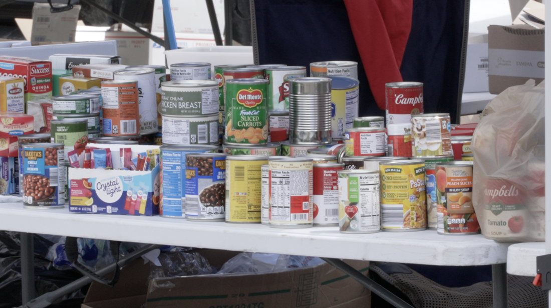 A table of canned food at the corner of Appleton and Seventh in Menasha.