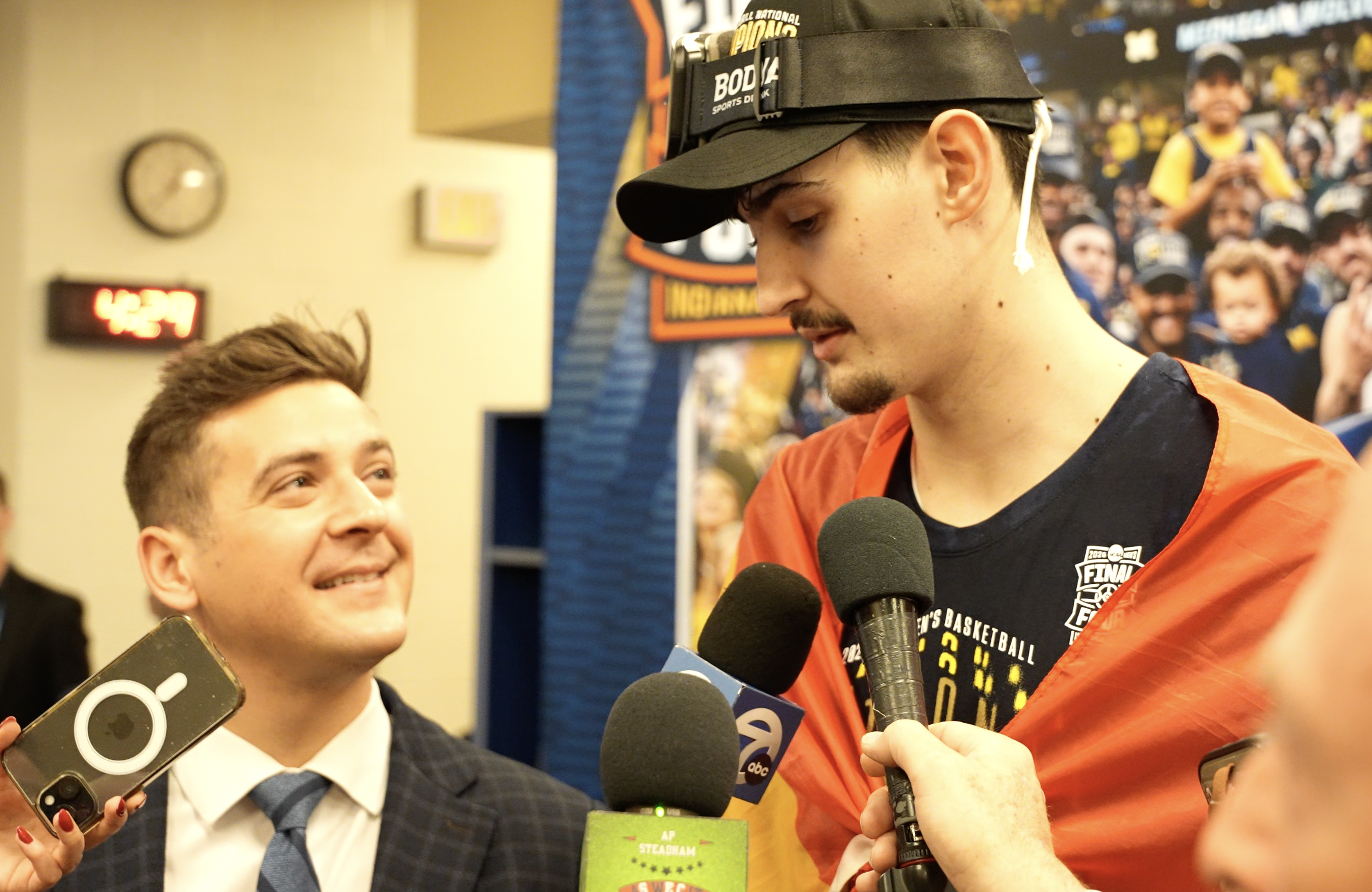 Michigan center Aday Mara talks with Brad Galli after the Wolverines won the national championship in Indianapolis on April 6, 2026