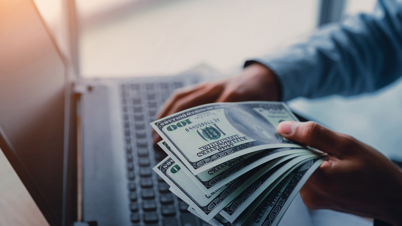 Cash money and a laptop computer
