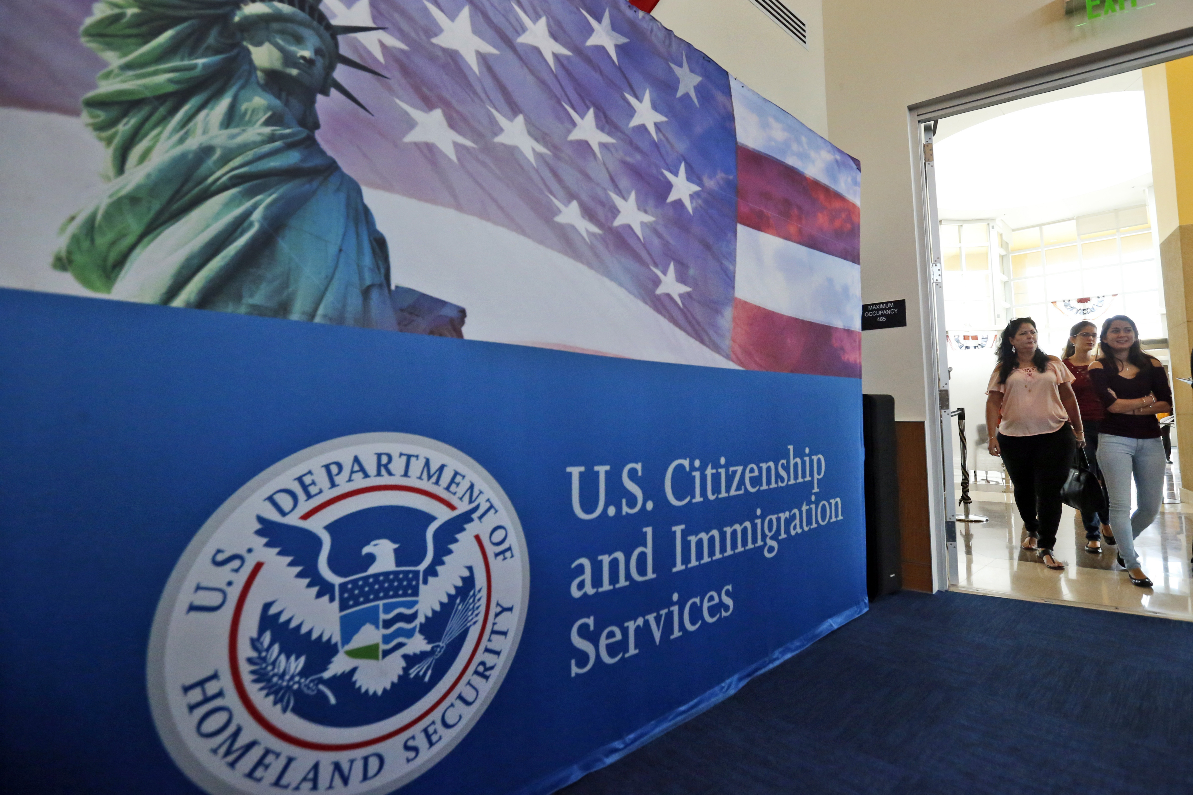 FILE - In this Aug. 17, 2018, file photo, people arrive before the start of a naturalization ceremony at the U.S. Citizenship and Immigration Services Miami Field Office in Miami. The number of applications for visas used in the technology industry soared for a second straight year, raising “serious concerns” that some are manipulating the system to gain an unfair advantage, authorities said Friday. There were 780,884 applications for H-1B visas in this year's computer-generated lottery, up 61% from 483,927 last year, U.S. Citizenship and Immigration Services said in a message to “stakeholders.” 