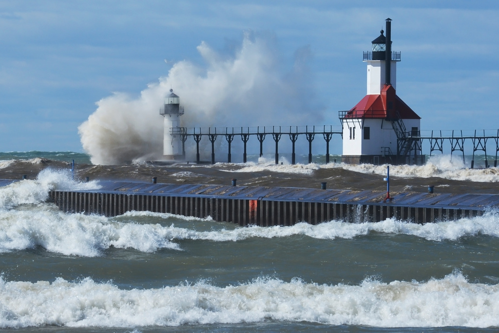 Waves crash into the St. Joseph Inner and Outer Lighthouses Friday, March 13, 2026, in St. Joseph, Mich., during high wind warnings.(Don Campbell/The Herald-Palladium via AP)