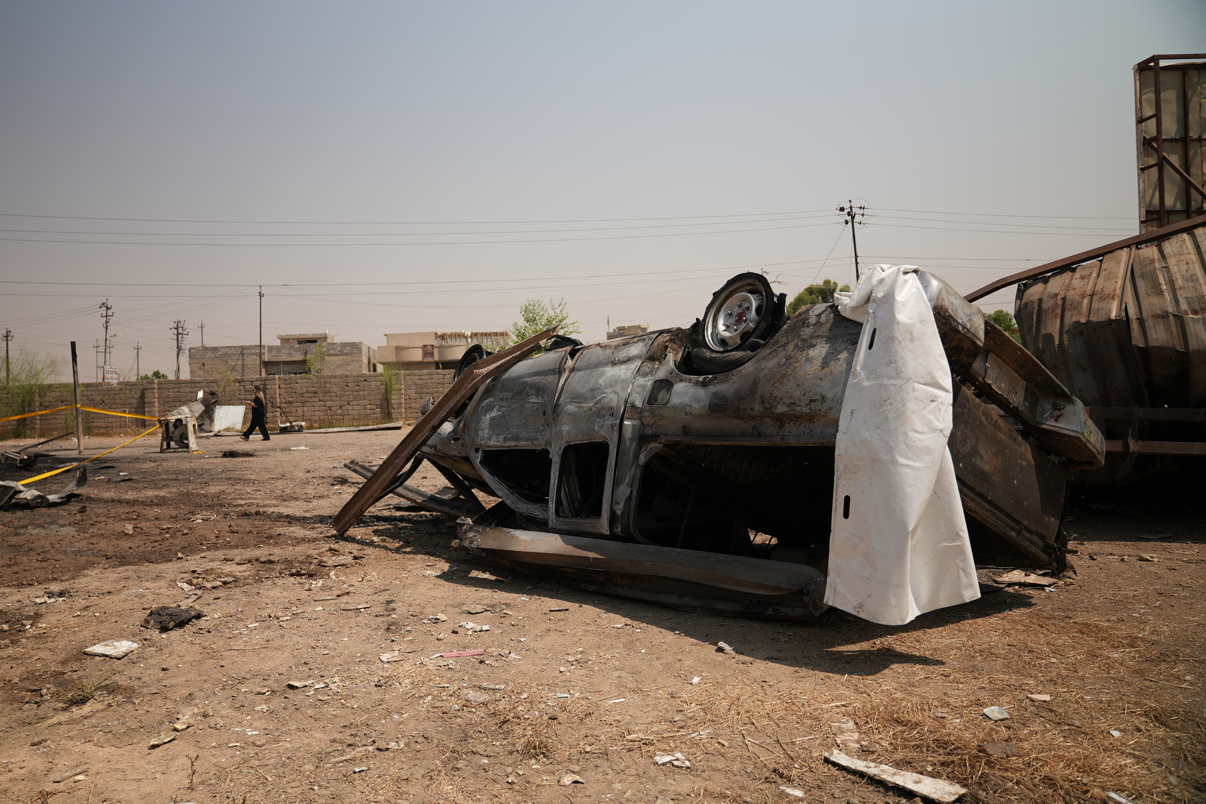 A damaged vehicle at the site of an airstrike on a Popular Mobilization Forces base in Mosul, Iraq, Wednesday, July 29, 2026.