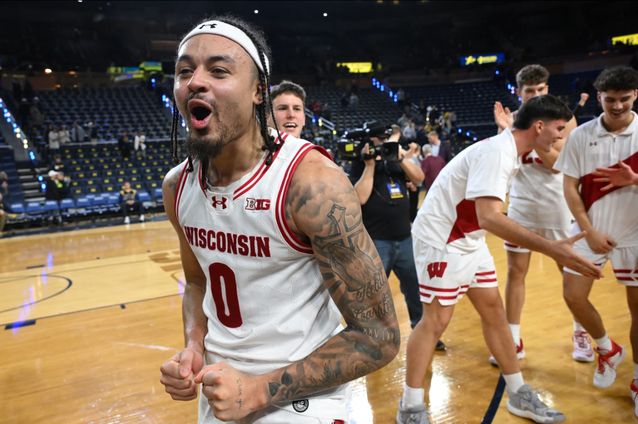 Wisconsin guard Braeden Carrington (0) celebrates with his teammates after they beat Michigan after an NCAA college basketball game in Ann Arbor, Mich., Saturday, Jan. 10, 2026.