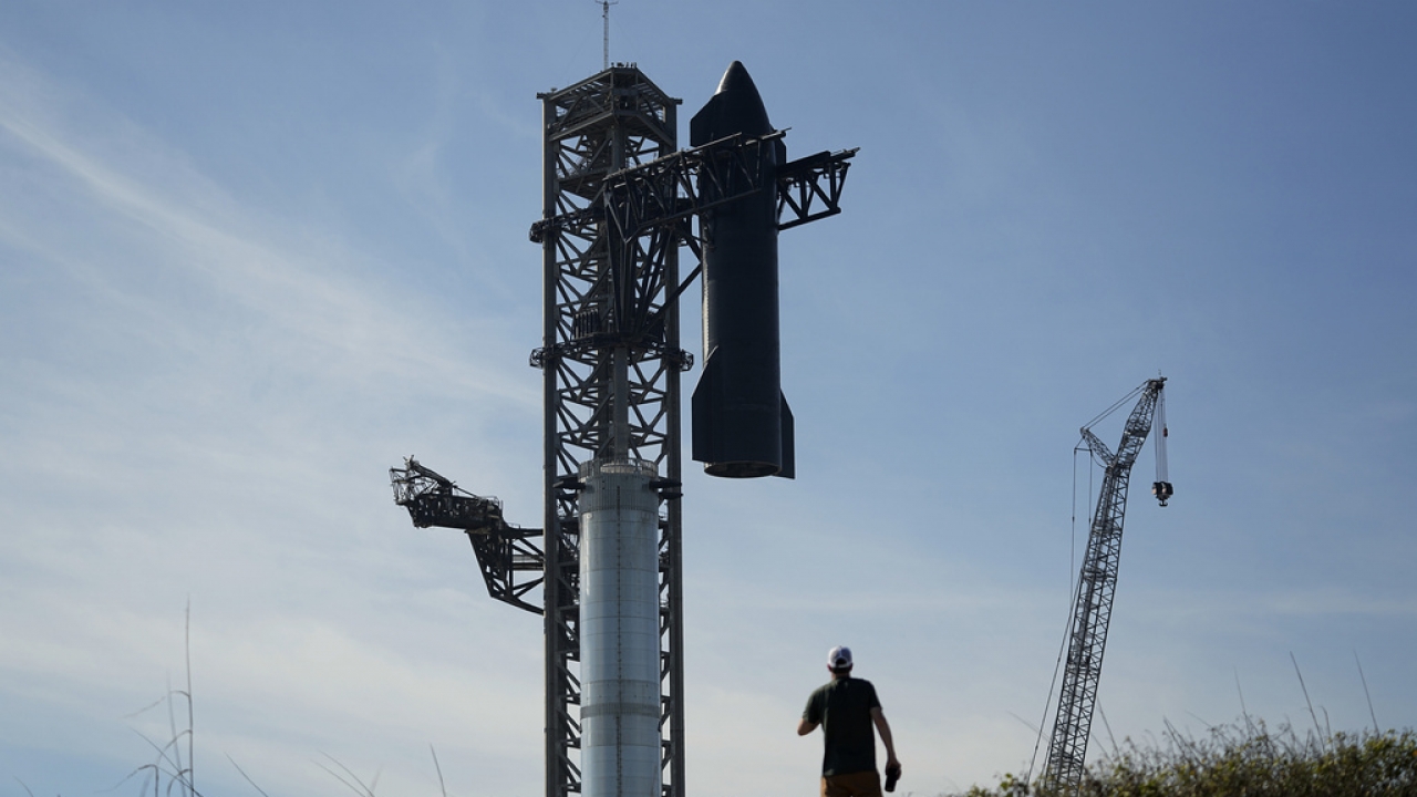 Onlookers watch as SpaceX's mega rocket Starship is prepared for its upcoming launch.