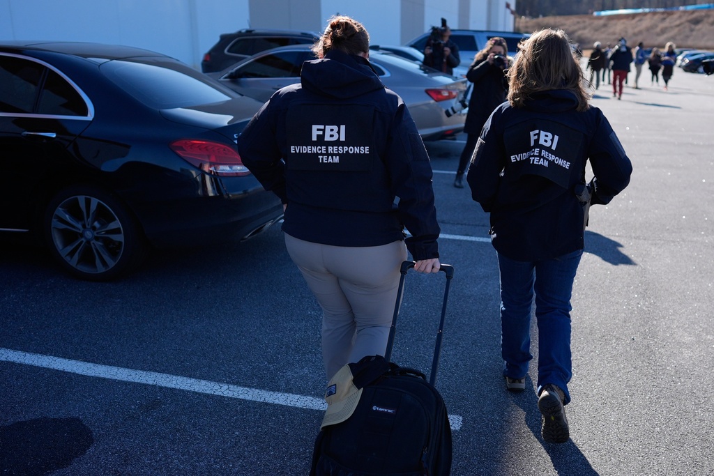 FBI officers are seen at the Fulton County Election Hub and Operation Center, Wednesday, Jan. 28, 2026, in Union City, Ga, near Atlanta. 