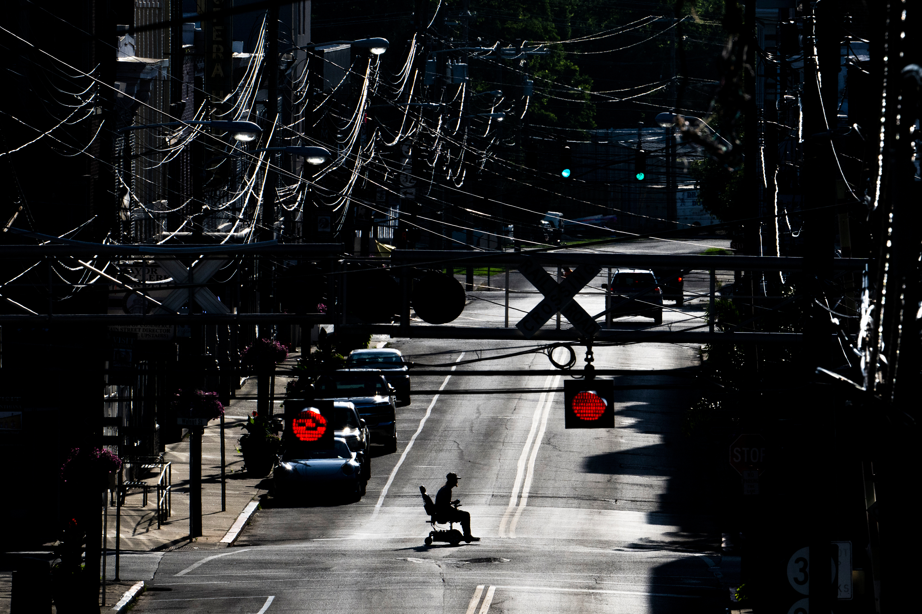 FILE - A man in an electric wheelchair crosses Pike Street in downtown Cynthiana, Ky., on June 23, 2025. 